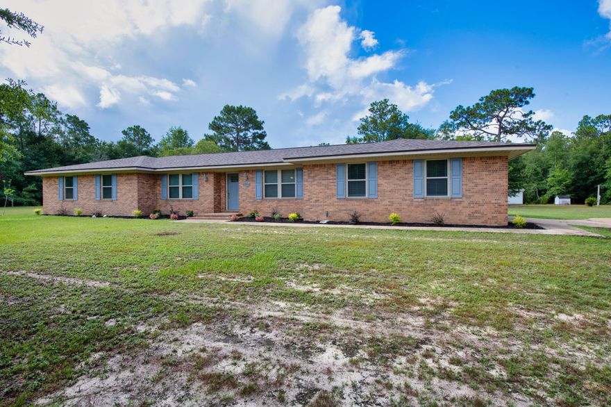 Discover this stunning 4-bedroom, 3-bathroom home set on 5 acres, showcasing modern updates and serene surroundings. Enjoy peace of mind with a new roof (January 2023), HVAC (2017), hurricane shutters (2017) and brand-new water heater. The home features new bamboo hardwood floors, new stainless steel appliances, quartz countertops, and new tile floors. New windows (2017) fill the space with natural light, while the updated gas fireplace, which can be converted back to wood-burning, adds cozy charm. The fenced-in backyard is a private oasis with an in-ground pool (liner is 2 years old), an updated shed, and a large workshop. Note: the well pump in the back is non-working and conveys as-is. This property offers the perfect blend of luxury and comfort.
