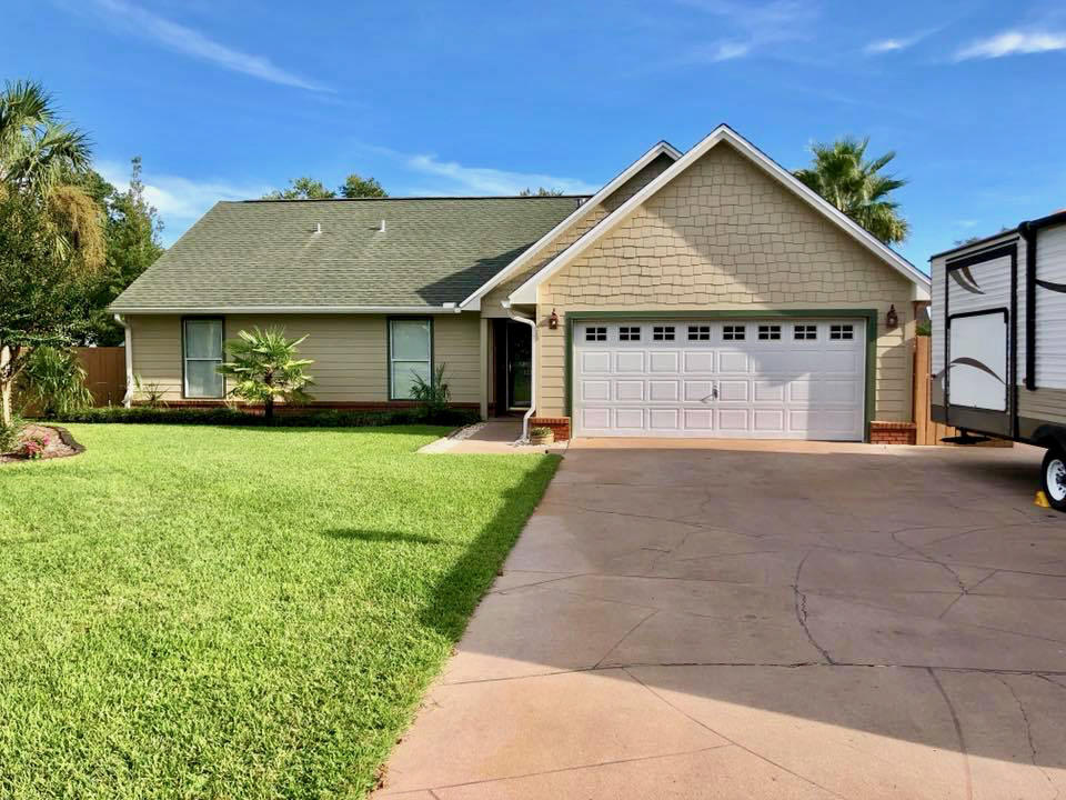 If you are looking for a house that has it all, look no more. This FIVE bedroom, THREE bath home is a rare find. Care of ownership is evident all around. As you approach the home you will note the extra pad in the driveway for storing your RV or boat. The house is equipped with full hook ups. There is a 50 amp outlet in the garage and a sewer hook up on the side of the driveway. Upon entering you will see tile floors in the kitchen, as well as all stainless steel appliances. The living room and dining room have all hardwood flooring and the open attached FL room has all tile floors and beautiful shiplap walls. The downstairs has two guest rooms and a guest bath as well as the master suite. Upstairs you have two large guest rooms and a full guest bath.