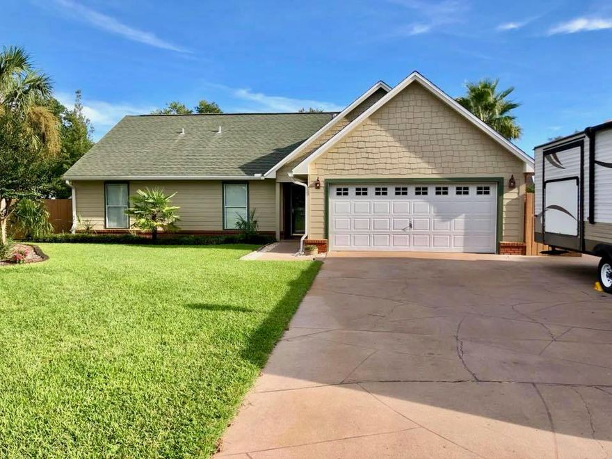 If you are looking for a house that has it all, look no more. This FIVE bedroom, THREE bath home is a rare find. Care of ownership is evident all around. As you approach the home you will note the extra pad in the driveway for storing your RV or boat. The house is equipped with full hook ups. There is a 50 amp outlet in the garage and a sewer hook up on the side of the driveway. Upon entering you will see tile floors in the kitchen, as well as all stainless steel appliances. The living room and dining room have all hardwood flooring and the open attached FL room has all tile floors and beautiful shiplap walls.  The downstairs has two guest rooms and a guest bath as well as the master suite. Upstairs you have two large guest rooms and a full guest bath.