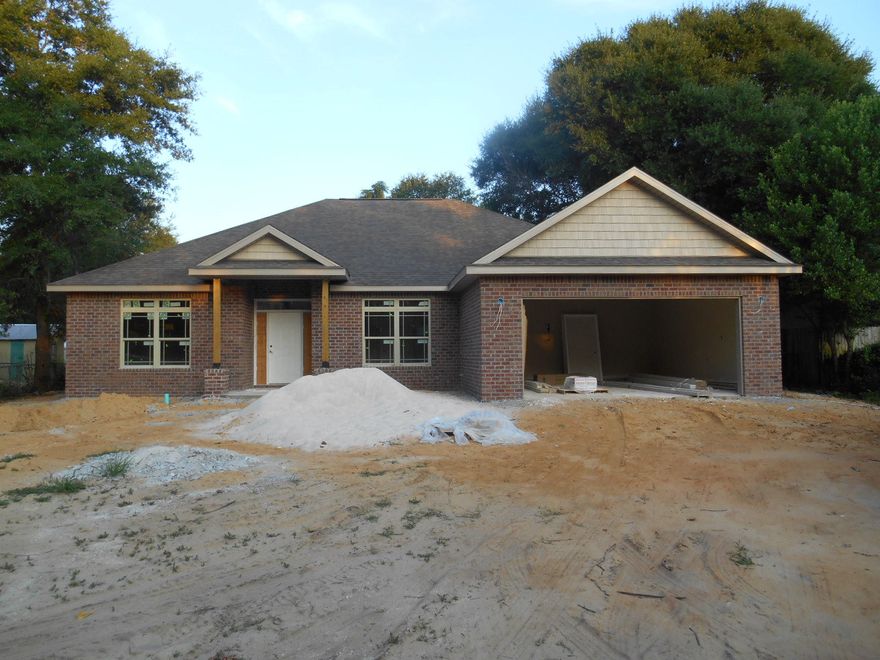 This is another quality new home built by an award winning VA approved builder in a convenient central Fort Walton Beach location. Many features that other builders call upgrades are included as standard features in this home. Features such as Granite Counter tops, Designer Cabinetry with soft-close drawers, Porcelain Tile in the Wet areas, Tumbled stone back splash in the kitchen, Automatic irrigation system with a shallow well, GE Stainless Steel appliances, Tray ceilings in the Living Room and Master Bedroom, Covered Lanai with Ceiling Fan, Finished and trimmed garage with quiet belt driven garage door opener, Fabric Hurricane shutters for all windows and doors with exterior hardware pre-installed, Quiet Zone insulation for the Master Bedroom separates sound from the main living area.