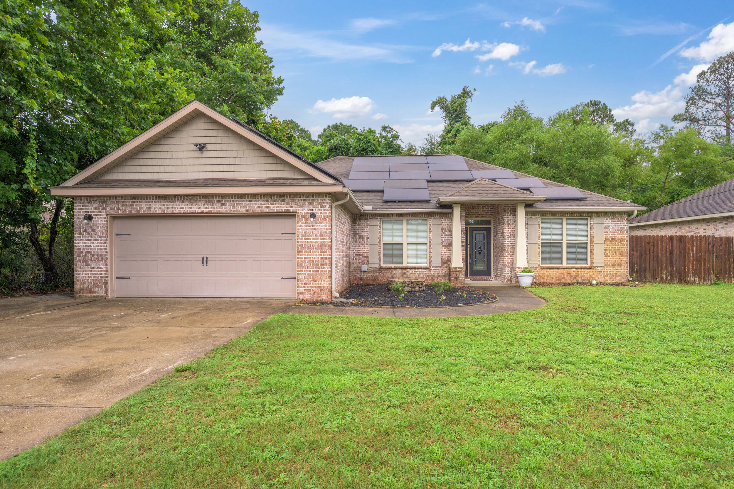In your home-buying ERA? Check out this fantastic 4 bedroom, 2 bath brick home with an open floor plan and an easy commute to military installations (about 5 miles to Eglin Air Force Base; approx 9 miles to Duke Field/7th group) schools, shopping, restaurants, and medical facilities. Going green is not a beige flag!!! Adulting is easier with solar panels: these panels will be paid for by seller at closing and seller says his monthly average electric bill is less than $100 due to offset from solar panels--Good for the environment, even better for your wallet so you can spend your hard-earned cash on other things. The solar panels add up to significant savings every month with an expected estimated 20 years or more of full output. Double pane windows, brick, newer home = energy efficient! From the beautiful front door and foyer you can see the high ceilings with decorative tray details. No CARPET: Luxury vinyl plank and tile floors throughout; gorgeous granite counter tops, stainless appliances, and big windows are among the many outstanding features of this home. Split bedroom floor plan with an open kitchen/dining and living space make the home live large. The master bathroom offers a large tub and a separate shower, and a massive closet. The front bedroom is set up as an office with a keypad entry. Huge windows let in lots of natural light. Enjoy the Florida lifestyle on your screened back porch overlooking the privacy fenced yard. Mature trees nearby add shade and birds/wildlife abound! Park your boat/jet skis on the extra parking pad on the side of the house. A great location only 13 miles to the sugar-white sandy beaches of Okaloosa Island!