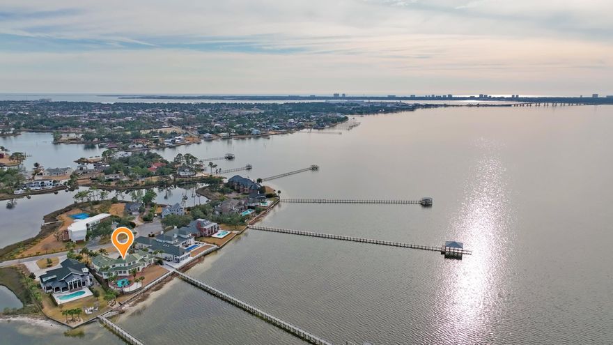 Stunning Bayfront Estate in Kings Point - A Waterfront Masterpiece with 3 car garage, pool, boat dock and all day breath taking views. Experience luxury waterfront living in this breathtaking 6,500 sq. ft. bayfront estate in the highly sought-after Kings Point community. With unparalleled panoramic views, this exceptional home is designed for those who appreciate elegance, comfort, and an effortless connection to the water. Boasting four spacious bedrooms, six full baths, and one half bath, this residence is a true sanctuary. The open-concept design showcases soaring ceilings, expansive windows, and seamless indoor-outdoor living, all designed to capture the beauty of the bay. Property Highlights:** Four oversized bedrooms, each with a spa--like en-suite bath. Six full baths plus one half  bath for ultimate convenience. Chef's kitchen with premium appliances, custom cabinetry, and expansive island Open-concept living spaces with floor-to-ceiling windows and panoramic bay views Private boathouse and dock, perfect for boating, fishing, and waterfront adventures Resort-style inground pool with a sun-drenched deck and lush landscaping Expansive outdoor living areas designed for entertaining and relaxation Unrivaled sunset views that create a stunning backdrop year-round This home is a rare opportunity to own a true bayfront masterpiece, where luxury meets tranquility. Schedule your private tour today and experience the ultimate in waterfront living.