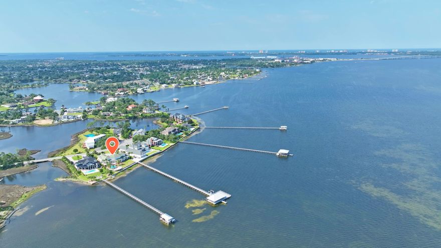 Stunning Bayfront Estate in Kings Point - A Waterfront Masterpiece with 3 car garage, pool, boat dock and all day breath taking views. Experience luxury waterfront living in this breathtaking 6,500 sq. ft. bayfront estate in the highly sought-after Kings Point community. With unparalleled panoramic views, this exceptional home is designed for those who appreciate elegance, comfort, and an effortless connection to the water. Boasting four spacious bedrooms, six full baths, and one half bath, this residence is a true sanctuary. The open-concept design showcases soaring ceilings, expansive windows, and seamless indoor-outdoor living, all designed to capture the beauty of the bay. Property Highlights:** Four oversized bedrooms, each with a spa--like en-suite bath. Six full baths plus one half  bath for ultimate convenience. Chef's kitchen with premium appliances, custom cabinetry, and expansive island Open-concept living spaces with floor-to-ceiling windows and panoramic bay views Private boathouse and dock, perfect for boating, fishing, and waterfront adventures Resort-style inground pool with a sun-drenched deck and lush landscaping Expansive outdoor living areas designed for entertaining and relaxation Unrivaled sunset views that create a stunning backdrop year-round This home is a rare opportunity to own a true bayfront masterpiece, where luxury meets tranquility. Schedule your private tour today and experience the ultimate in waterfront living.