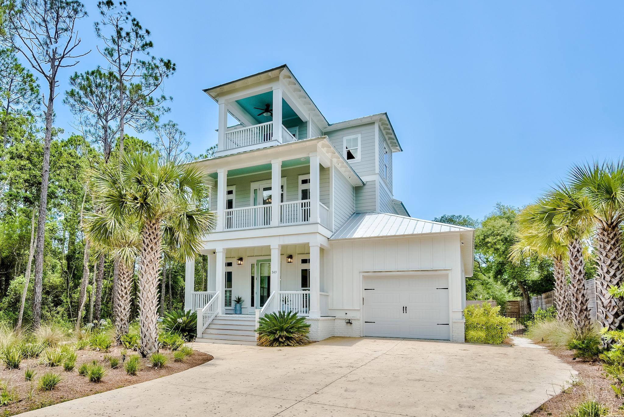 Located on the sought-after street of Seacrest Drive, this picturesque beach house boasts over 2,900 square feet of thoughtfully designed living space. Situated on a half-acre, the homesite offers privacy and ample outdoor living space centered around the custom resort-styled pool. The interiors are adorned with hardwood floors, shiplap accents, a chef's kitchen, and high-end finishes throughout. The first-floor main suite features a sumptuous ensuite with a soaking tub, custom tiled shower, double vanities, and an oversized walk-in closet. The second floor is home to a second suite in addition to the remaining bedrooms.