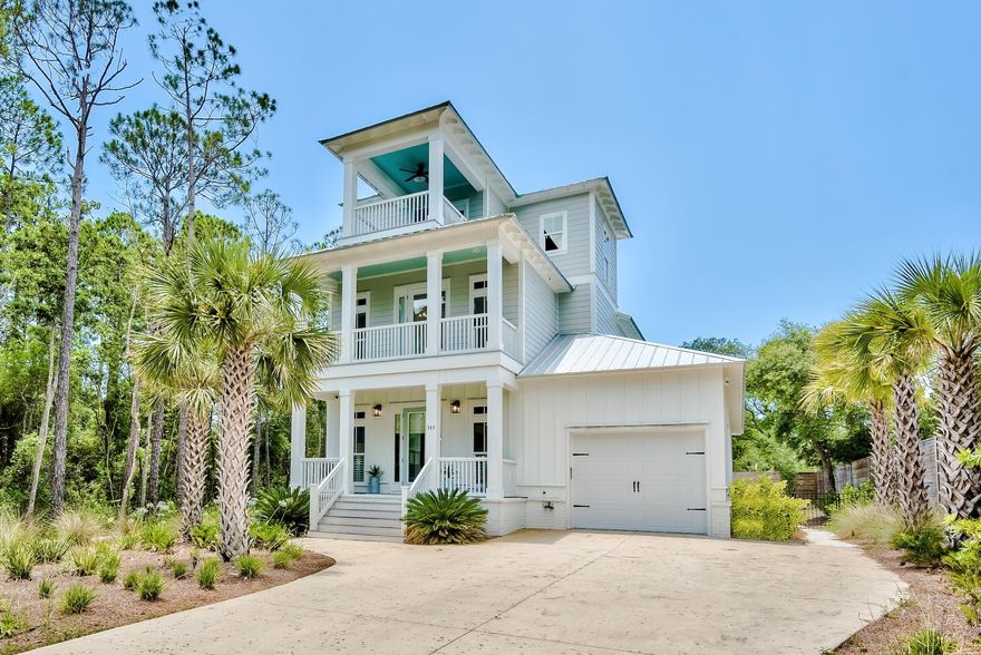 Located on the sought-after street of Seacrest Drive, this picturesque beach house boasts over 2,900 square feet of thoughtfully designed living space. Situated on a half-acre, the homesite offers privacy and ample outdoor living space centered around the custom resort-styled pool. The interiors are adorned with hardwood floors, shiplap accents, a chef's kitchen, and high-end finishes throughout. The first-floor main suite features a sumptuous ensuite with a soaking tub, custom tiled shower, double vanities, and an oversized walk-in closet. The second floor is home to a second suite in addition to the remaining bedrooms.
