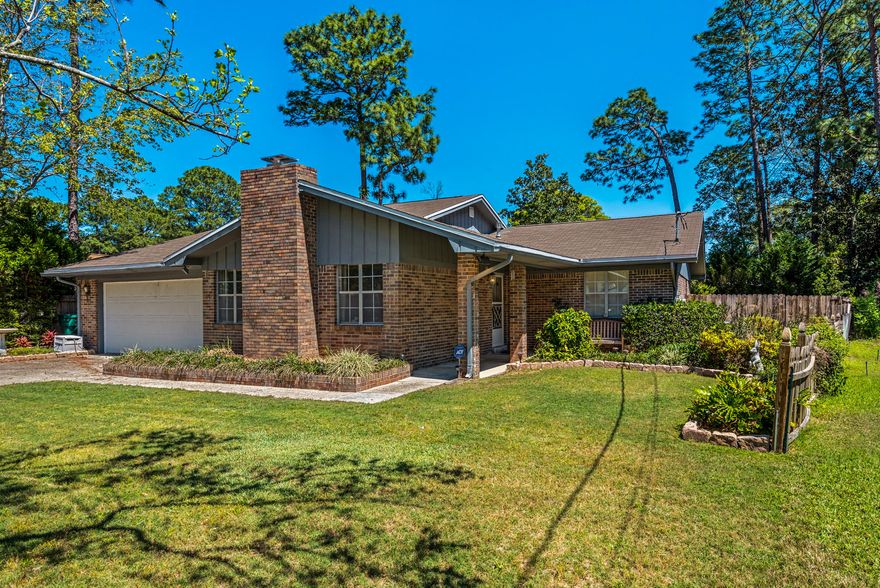 Welcome Home! This quintessential cutie is nestled in the heart of Niceville and the quiet community of Pinewood Estates. Filled with mature landscaping, beautiful garden beds, a pebble walking path and bricked walkway, the outside of this home beckons you to stay outdoors and enjoy your cup of morning coffee or evening tea! You can enjoy the peaceful setting from the screened porch or covered patio with full privacy. Inside this expansive home you'll find all tile and wood laminate flooring (no carpet!). Through the front door you'll enter to a combined living and dining space - flexible for what best suites your families needs! The kitchen boasts plenty of cabinets, a rollaway center island, a pantry, and a look thru nook to the oversized family room. Down the hall are three .....