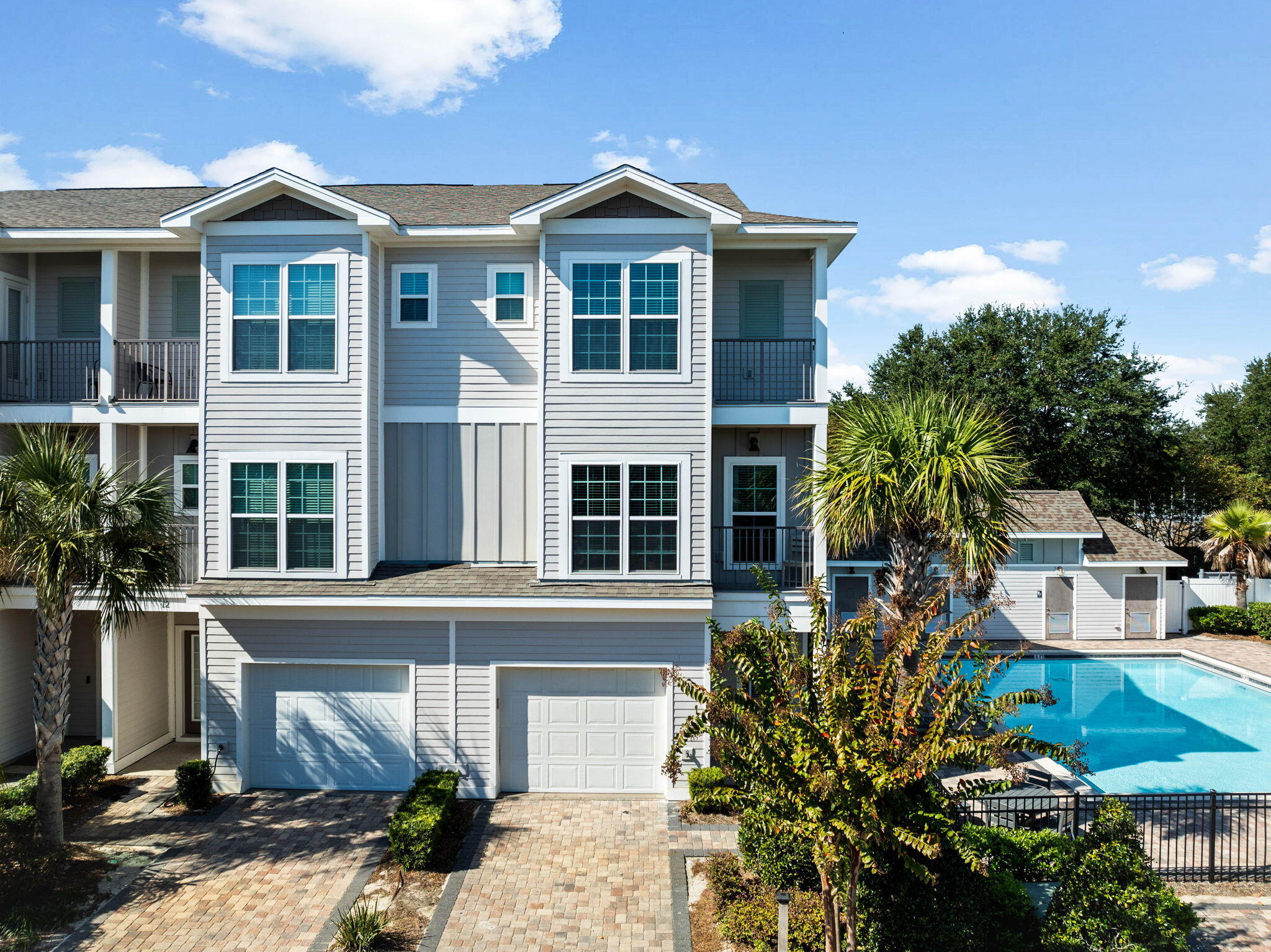 Driftwood Drive Townhomes is a 20 unit luxury complex prominently located in the heart of Miramar Beach. This coastal retreat offers an exceptional investment opportunity with only a 3 minute walk to the beach or several local restaurants! This fully furnished three story townhome features 4 bedrooms, 4 bath, 1 car garage, and a brick paver driveway. Corner unit allows you to sit on the balcony and watch your kids enjoying the community pool.  The first floor has a spacious bedroom with two built-in bunk beds, a full bath & a full size stackable washer and dryer. The main living area is on the second floor with an open living room, dining area/kitchen, bedroom & a second full bath. On the third floor you will find the master bedroom with the ultimate ensuite bath; a gorgeous oversized shower & soaking tub as well as another bedroom with a private bath and a second full size washer and dryer .Professionally furnished and decorated, this home features beautiful oak hardwood floors throughout, crown molding, porcelain tile and the private patio where you can relax and grill after a day at the beach. 