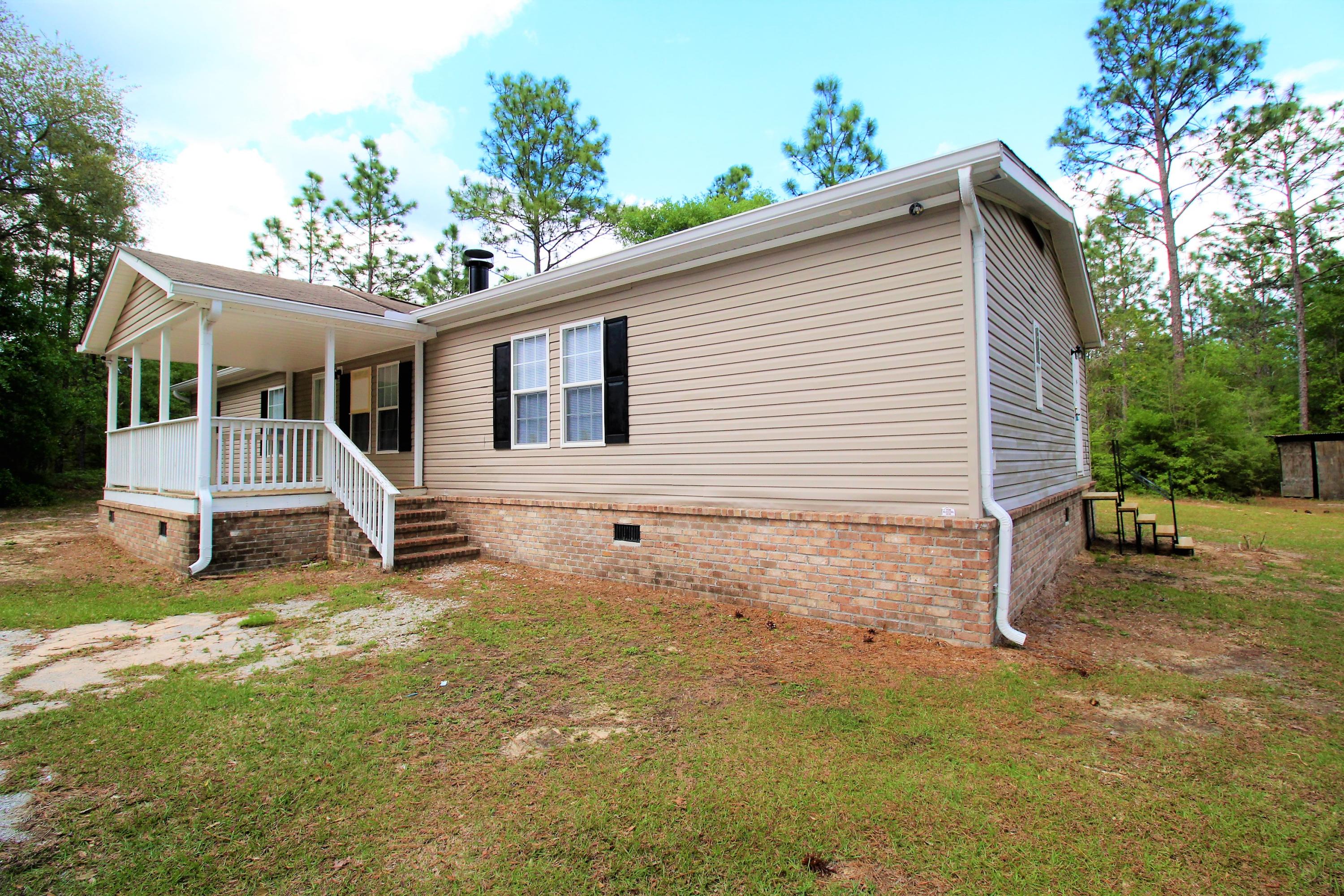 REO Spacious and updated 5 bedroom home in a private county setting! Outside you are welcomed by the large covered porch, perfect for relaxation. Inside, this home features custom two-toned wood grain flooring, a wood burning fireplace, large open kitchen, and a split floor plan. The master bedroom has a walk in closet and full en-suite with double sinks, garden tub, and separate shower. The other 4 bedrooms do not disappoint. All good sized rooms with a full hall bath and a jack-n-jill bath shared by the back 2 rooms. Sliding glass doors open from the dining room to new back deck overlooking a quiet, nature filled, 2 acres. *SELLER FINANCING AVAILABLE* all measurements approximate