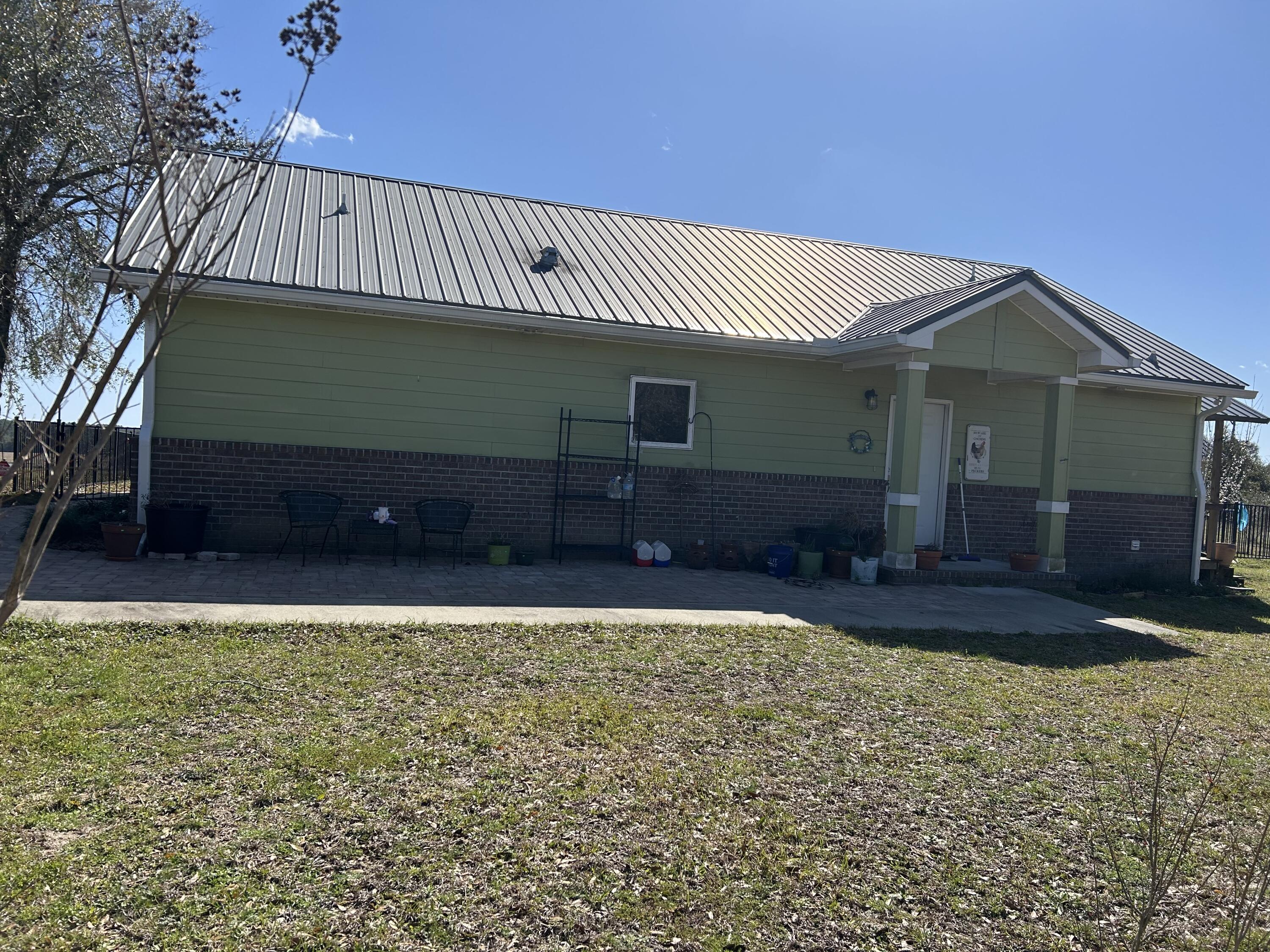 ESTATE SALE OF 10 ACRE RANCHETTE WITH PEAK VERSATILITY- PRIME SET-UP FOR HOMESTEAD EXPANSION OR GET AWAY RETREAT! Craftsman style cottage with rear covered porch overlooking in-ground pool, that flows into a side patio area (25x12) outdoor kitchen (24.5x24.5) w/bar. A workshop (40x25) with partial power, 2nd floor loft, and lean to on each side-one w/concrete slab ideal for parking vehicles/equipment. Additional pavilion w/unfinished greenhouse. Home has gas fireplace in family room open kitchen w/work island, large BR/Full bath on each side. Wall safe in walk-in closet of owner's suite, and tiled walk-in shower. Property has fruit trees, many types of fencing, power & water to cleared area past pavilion for additional homesite. Solar panels will be paid off at closing - sold ''as is''