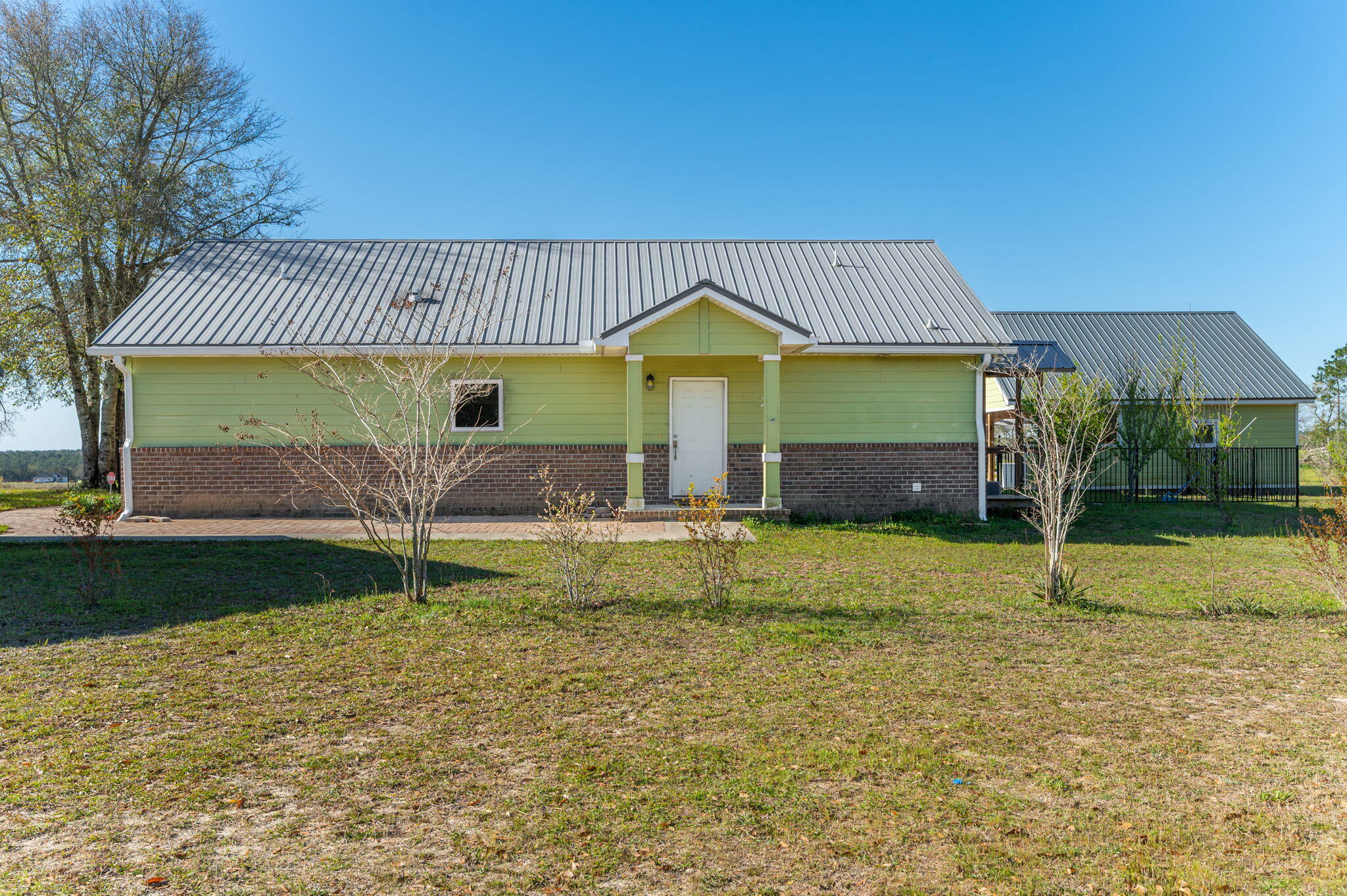 ESTATE SALE OF 10 ACRE RANCHETTE WITH PEAK VERSATILITY- PRIME SET-UP FOR HOMESTEAD EXPANSION OR GET AWAY RETREAT! Craftsman style cottage with rear covered porch overlooking in-ground pool, that flows into a side patio area (25x12) outdoor kitchen (24.5x24.5) w/bar. A workshop (40x25) with partial power, 2nd floor loft, and lean to on each side-one w/concrete slab ideal for parking vehicles/equipment. Additional pavilion w/unfinished greenhouse. Home has gas fireplace in family room open kitchen w/work island, large BR/Full bath on each side. Wall safe in walk-in closet of owner's suite, and tiled walk-in shower. Property has fruit trees, many types of fencing, power & water to cleared area past pavilion for additional homesite. Solar panels will be paid off at closing - sold ''as is''