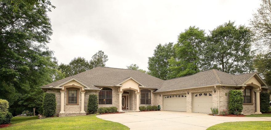 Exquisite All Brick 3 Bedroom, 3 Bath home, South of I-10, with study/office, sun room and a heated/enclosed pool, on .48 acres located in the highly desired neighborhood of Juniper Creek Estates. Fantastic floor plan with 12 foot trey ceilings, hardwood floors in the living and dining areas, tile floors in the kitchen/bathrooms and carpeted bedrooms. Incredible kitchen accented with pendant and recessed lights, granite counter tops, island, stainless appliances, new door hardware and soft close drawers and a convection/microwave oven. The huge master suite has his and her walk in closets, dressing area, double vanities, king sized marble shower and garden tub. The extended custom lanai with Italian cypress opens up to your heated enclosed pool with hot tub. This is a MUST SEE