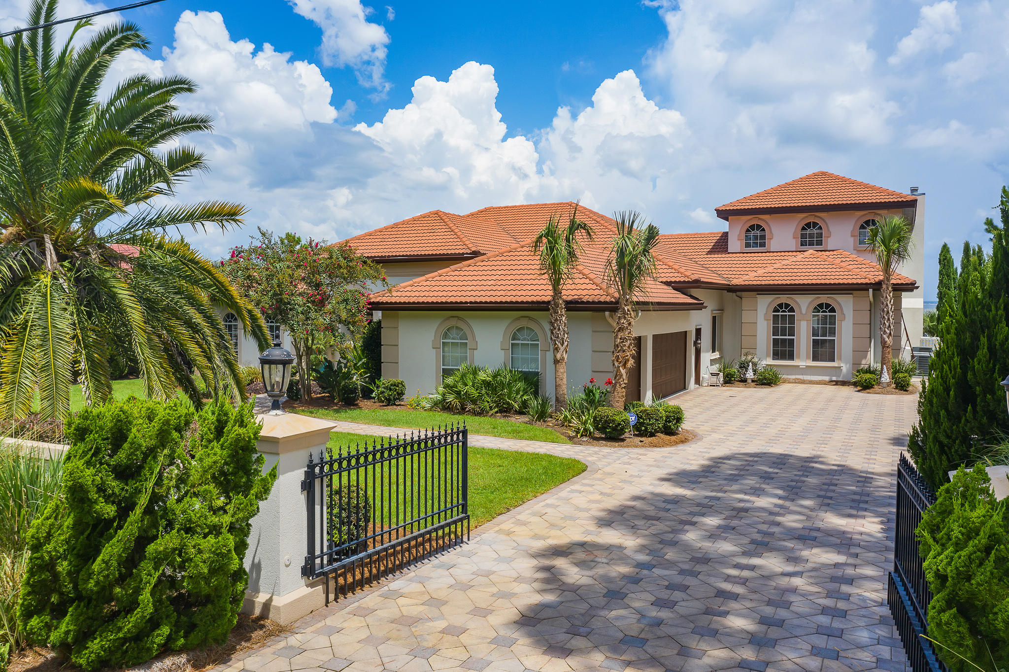 Extensively updated and offering exquisite amenities, this bayfront estate has been customized to provide luxurious waterfront living on the iconic Emerald Coast. Well-maintained, the property's mature landscaping and inspiring exterior command attention upon entering the long, gated driveway. An open entry reveals stone flooring, high ceilings, and sophisticated living areas. Featuring over 5,000 sq ft of living space, entertain easily with two formal living rooms, a family room with built-in shelving, and a formal dining room. The gourmet kitchen offers a Thermador range, custom-painted cabinetry, ample storage, and a bar area for mixing and serving drinks. Additionally, this home also includes a wine cellar.