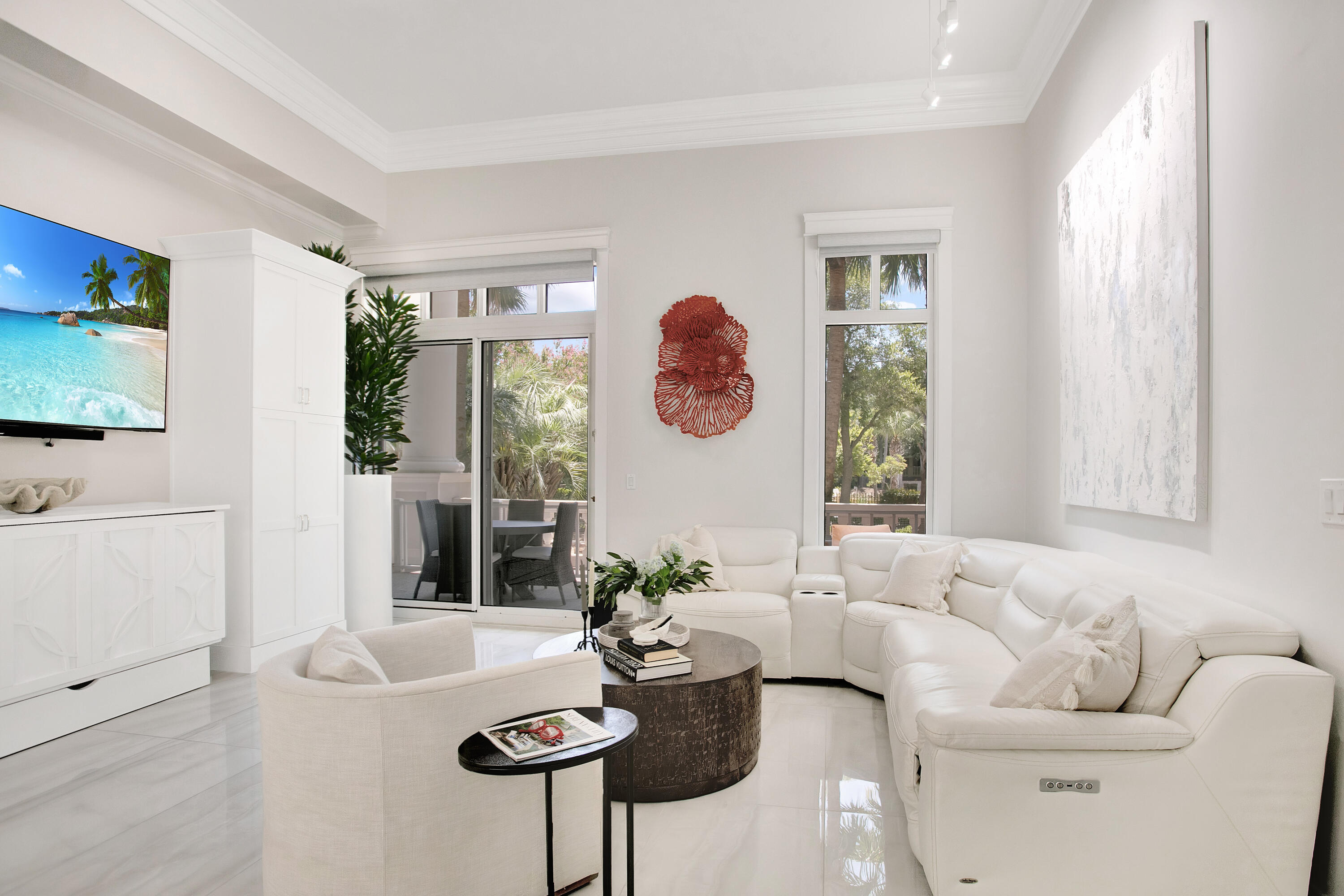 Impeccable Style & Custom Luxury in Grand Sandestin. This completely renovated residence in the Grand Sandestin showcases meticulous craftsmanship and elevated design, offering one of the most impressive & unique condominiums in the building. As a ground-floor unit, it provides effortless access and added convenience--no elevators required. Step inside to discover soaring 13.4' ceilings, 24'' x 48'' polished onyx white porcelain flooring, custom LED lighting throughout (all on dimmers), and textured wall tile that adds depth and dimension. The living space is enhanced with built-in shelving, a premium sound system (soundbar, subwoofer, & two small speakers), and custom furnishings including a 75'' and 85'' television. The gourmet kitchen features stainless steel appliances, quartz countertops, under-cabinet and under-counter lighting, and a sleek breakfast bar with seating for four.
The spacious primary suite includes a Tempur-Pedic adjustable bed, two Serena & Lily Driftway 3-drawer nightstands in Coastal Blue, and remote-control window treatments. Both spa-inspired baths boast frameless glass walk-in showers, quartz counters, and lighted mirror vanities.
A queen-size Murphy bed tucked beneath the custom media hutch offers sleeping space for up to four guests. Additional upgrades include a new LG washer & dryer, Halo water detection system, custom acrylic closet shelving with a 36" brass rail, and a matching row of acrylic wall hooks, installed automatic charging for electric blinds and updated owners closet.
Enjoy your private outdoor space with a new matching lounge chair, and take advantage of the owner's closet and storage cage. Grand Sandestin owners have exclusive access to a resort-style pool, spa, kiddie pool, grilling area, and fitness center.
Exclusion: White Bedroom Chest, Outdoor Concrete Table and Chairs, White swivel chair in living room, personal belongings in built-ins and closets, items in storage cage, work computer, monitors and printers.
As an introduction to the Sandestin lifestyle, we invite our new owners to explore amenities that make Sandestin special. The listing brokerage and seller(s) are presenting the buyer(s) of this property with (2) 90-minute rounds of Tennis court time, a golf foursome at one of our three championship courses, and a round of golf for up to four (4) players at the unrivaled Burnt Pine Golf Club.
Sandestin Golf and Beach Resort features more than seven miles of beaches and pristine bay front, four championship golf courses, 15 world-class tennis courts, a 226-slip marina, a fitness center, spa and celebrity chef dining. Shop, dine and play at the charming pedestrian village, The Village of Baytowne Wharf and more. Inside the gates of the resort, residents enjoy a balanced lifestyle of high-class living, spanning the 2,400 acres from the beach to the bay. Everything within the gates of the resort is accessible by golf cart or bicycle. The entire resort is interconnected by miles of pedestrian, bike and golf cart paths that weave through groves of live oaks, meandering past natural lagoons, fountains, man-made lakes, and meticulously landscaped fairways.