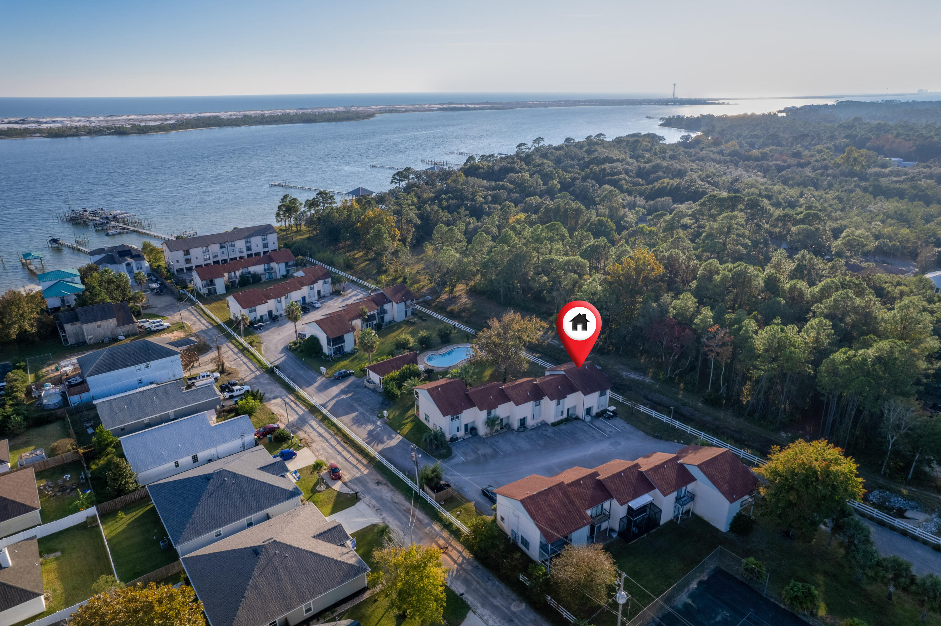 48k annual revenue per projections! Waterfront Community Conveniently located just 2 miles to Hurlburt Field, this townhome offers an immaculate, bright, and neutral interior, a screen enclosed balcony overlooking the community swimming pool and water view, and a boat slip. You'll enjoy the generously sized granite peninsula overlooking the open concept living and dining area, which makes for a great place to entertain family and friends. The kitchen offers abundant cabinet storage, a breakfast bar suitable for seating 3 or more, and a built-in wine cooler. The spacious living room and dining area show off the natural light with white marble-look porcelain tile. The primary suite is located on the water facing side of the unit and is suitable for a king-size bed. It comes complete with a