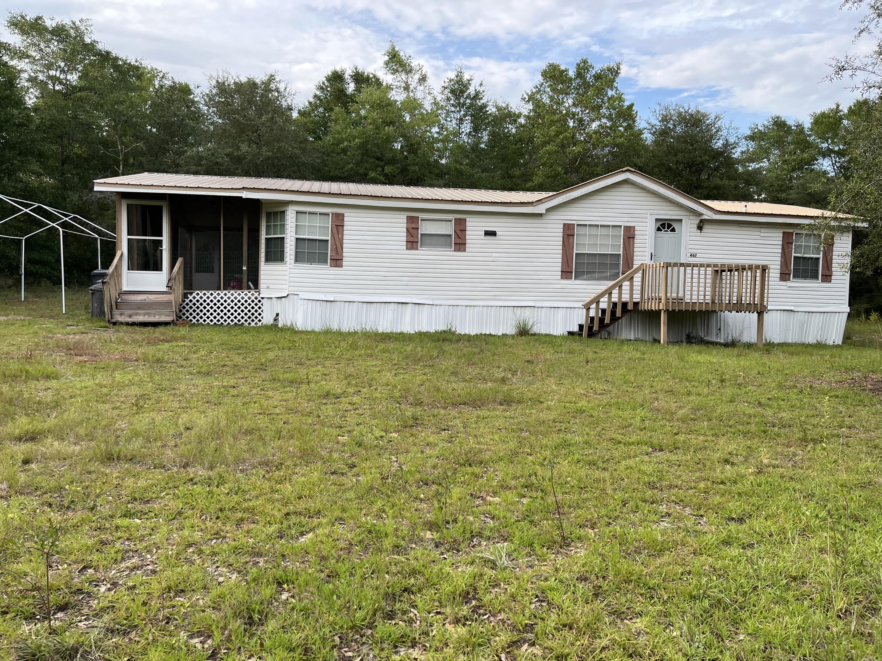 Discover your peaceful haven in DeFuniak Springs, Florida. This charming 3-bedroom, 2-bathroom mobile home is nestled on 1 acre of land, just minutes from Juniper Lake and the beautiful beaches offering the perfect balance of comfort, space, and convenience. Whether you're relaxing in the living room or entertaining guests, the home provides a warm and inviting atmosphere ideal for both everyday living and entertaining. The property offers a sense of seclusion while remaining conveniently located. Whether seeking a full-time residence or a peaceful getaway, this home is a great find in an ideal location. Would like to mention the metal roof is 6 years old and the Ac still has 4 years of the warranty left! Schedule your showing today!