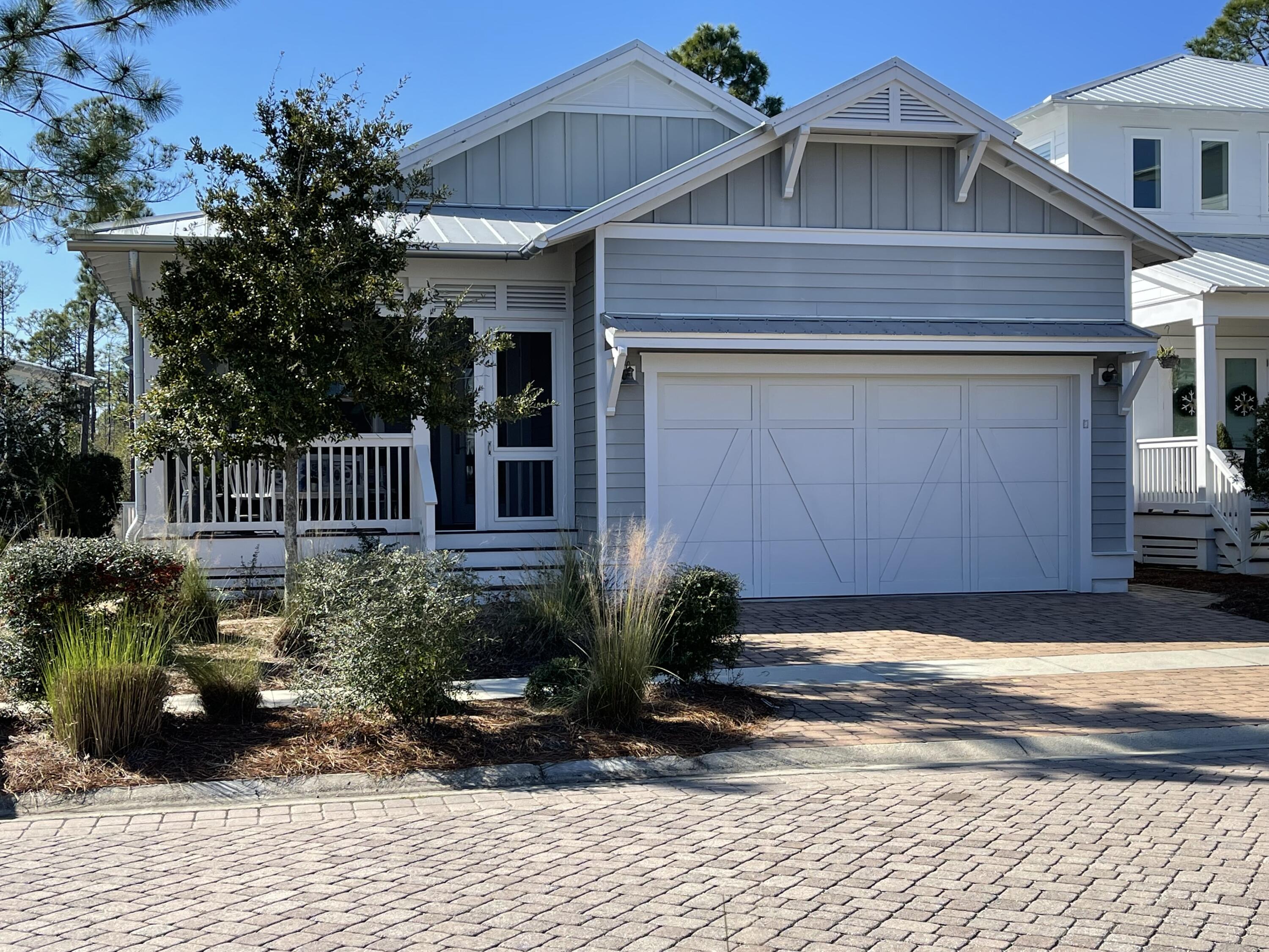 The ONLY single-story home available in NatureWalk and located across from the Serene Sunset Pond. This gorgeous, meticulously cared for Florida Cottage has never been a rental. Wonderful floorplan with a large family room which opens to a beautiful kitchen with breakfast bar. Kitchen finishes include Shrock quality cabinets with soft close drawers, custom quartz countertops and GE Cafe appliances, gas cooktop (GE monogram hood). Spacious master suite has tray ceilings and huge walk-in closet off master bath. Entertain guests in the large screened in front porch or in the dining room with beautiful chandelier. The back porch is a private oasis with no one living behind you...all preservation land.Let the picturesque wooden bridge of NatureWalk welcome you home to all the amenities.