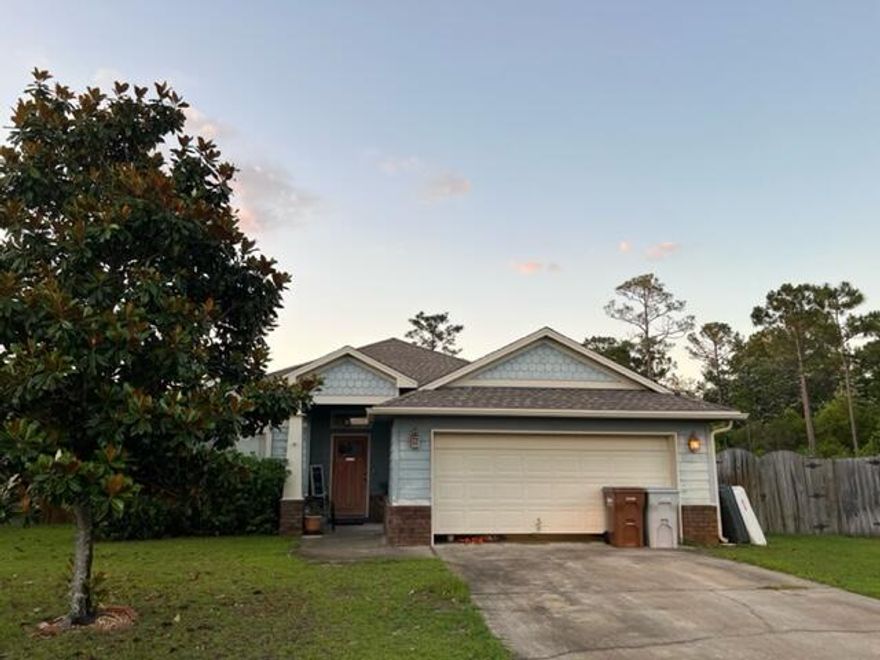 Beautiful East Navarre home in the desirable Cottages at East River subdivision move-in ready. Located conveniently for quick access to Highway 98, dining, shopping, and Navarre High School. This home features a spacious open floor plan and a covered patio overlooking a large fenced-in backyard. The unique cul-de-sac lot makes it one of the largest in the neighborhood! The kitchen is fully equipped with stainless steel appliances, granite countertops, upgraded drop pendant lights and a breakfast bar. The luxurious bathrooms have been upgraded with lighting and granite vanity tops. Lack of space won't be an issue here with the  separate dining area and an interior laundry room.