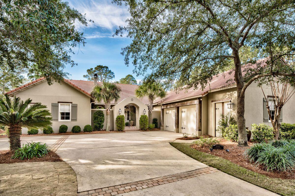 A versatile lifestyle is at the forefront of this bespoke home in Burnt Pine, with single-level living, a sizable yard and pleasant entertaining spaces offering numerous possibilities. Tucked away on a large, private lot, this home was inspired by A. Hayes Town and boasts his trademarks throughout with classic European features and French Creole influence. Lounge by the large pool or take in views of the lake with water feature from the covered porch. Entertain in a well-appointed kitchen with granite countertops, island with prep sink, walk-in pantry, Wolf stove with double ovens, Sub-Zero refrigerator, ice maker and more. Welcome guests to a comfortable great room with floor-to-ceiling custom cabinets beneath a lofty cathedral ceiling.
