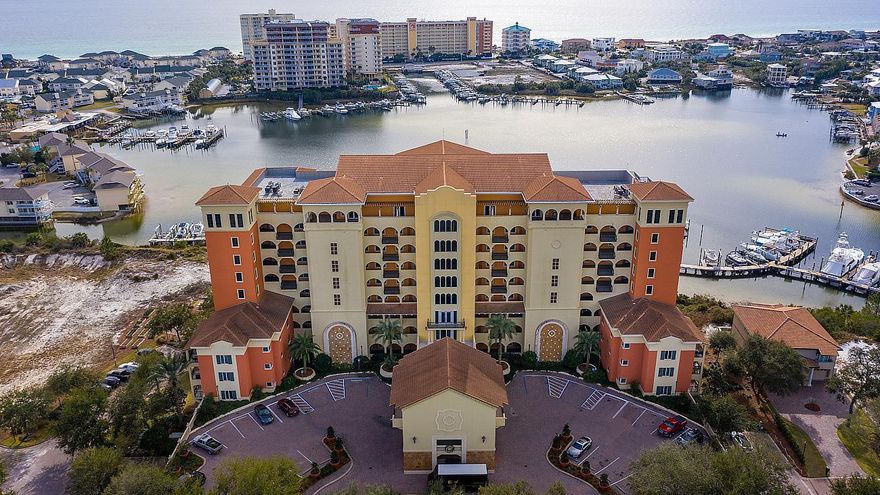 What a Beauty! Gorgeous Two Bedroom, West End, Fully Furnished, Luxury Condominium at waterfront Marbella fronting the glistening Destin Harbor with southwest balcony sunsets and water views! Interior features include open floorplan, high ceilings, crown moulding, beautiful textured hardwood floors, tile floors, granite countertops, kitchen breakfast bar, and spacious Master Bedroom Suite with balcony access, large walk-in closet, extended Master Bathroom double vanity, whirlpool tub, and separate shower! Condominium conveys with large convenient Storage Unit and Two Covered Spaces. Marbella welcomes you in stunning ornate fashion as you enter the Main Entrance Foyer and Lobby to the Harbor-front Swimming Pool and Hot Tub to the scenic Marbella Harbor Marina Boardwalk! What a Gem!