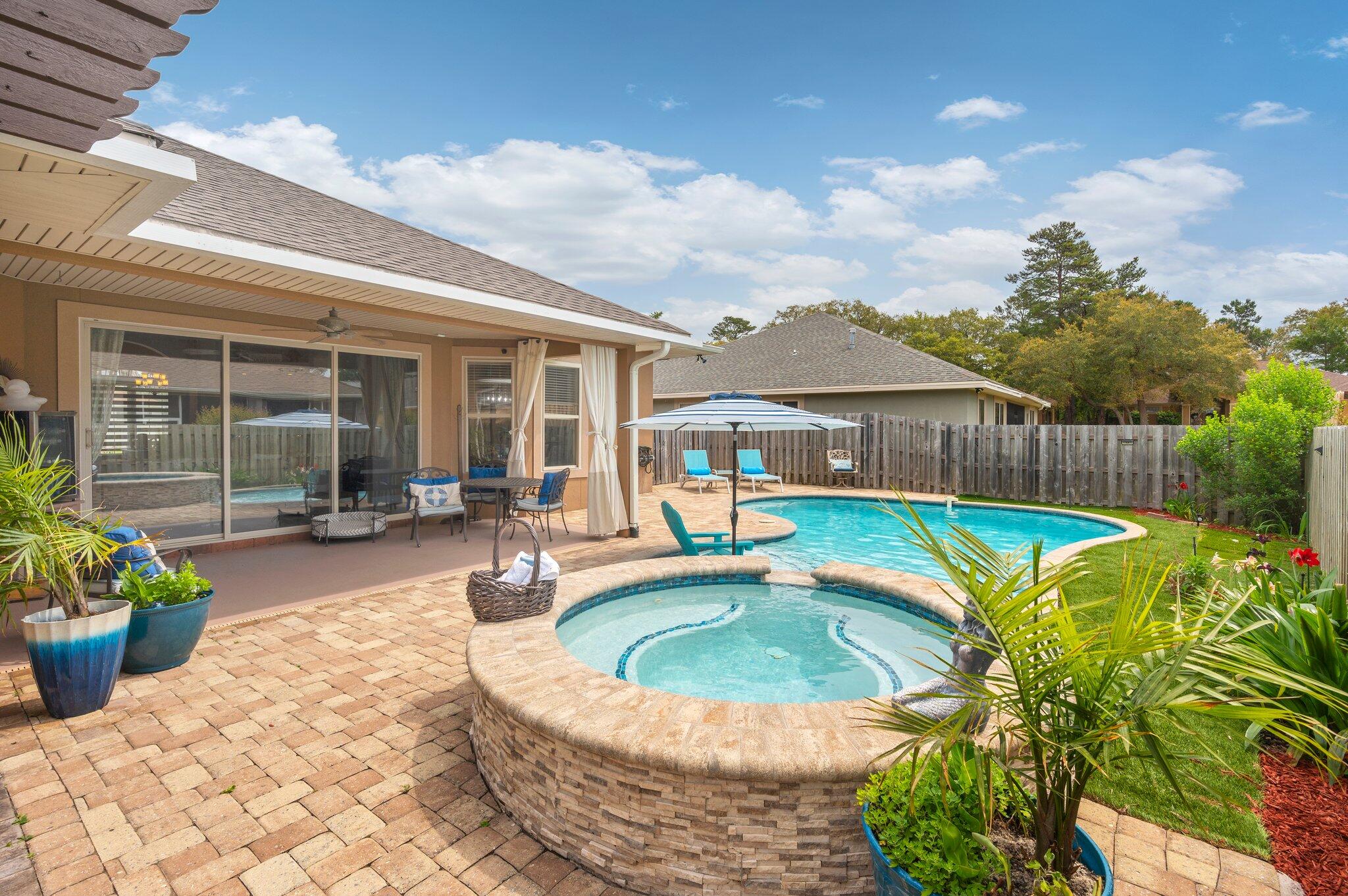 Welcome to luxury living in Chardonnay Estates, a wonderful Niceville community just minutes from everything you want...shopping, schools, restaurants, White Point bayfront Recreation area and the sugar white sands of the Destin beaches! You can vacation in your own back yard that is a private oasis featuring a heated salt water pool, spa and charming cedar pergola surrounded by maintenance free artificial turf! When you enter this home through the charming covered porch and wide foyer, you will find yourself in the living room accented with 11' coffered ceilings and a large sliding glass door opening to the pool area. Adjacent to the living room is the dining room offering a convenient wet