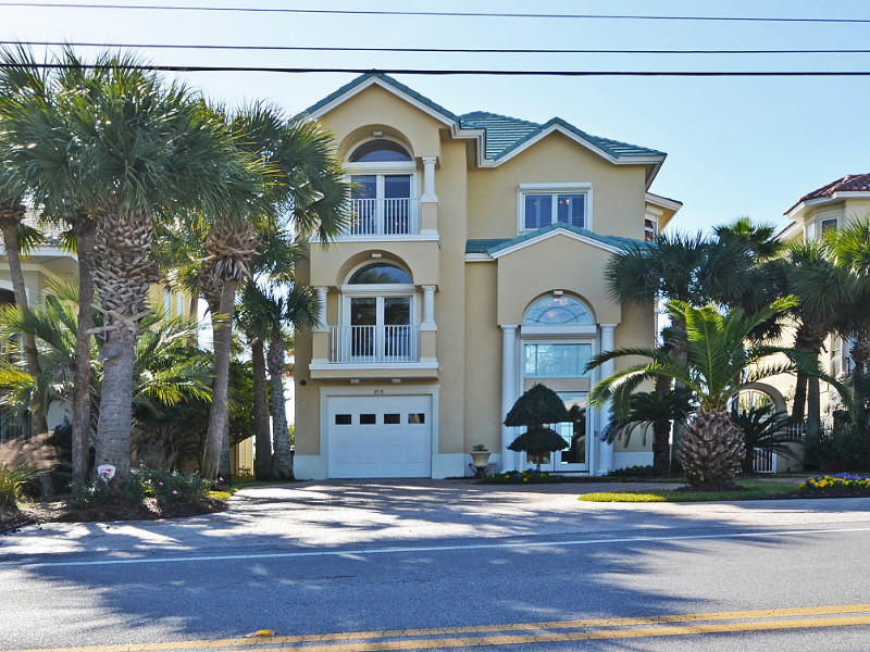 Experience gulf front living at its finest! This exquisite 3-story home is located directly on the beautiful emerald green waters of the Gulf of Mexico. This home features six bedrooms, six and a half baths and a separate lock out mother-in-law suite. Perfect for a personal residence, second home or a vacation/rental. Beautiful architectural features include, decorative crown molding, marble flooring, custom plantation shutters. The home has a total of 6,125 sq. ft. under roof with 4,058 sq. ft. heated/cooled space. All luxurious levels open to large balconies overlooking the beautiful Gulf of Mexico. All balconies are equipped with flat screen TVs, perfect for entertaining. All levels are easily accessible with your private elevator.