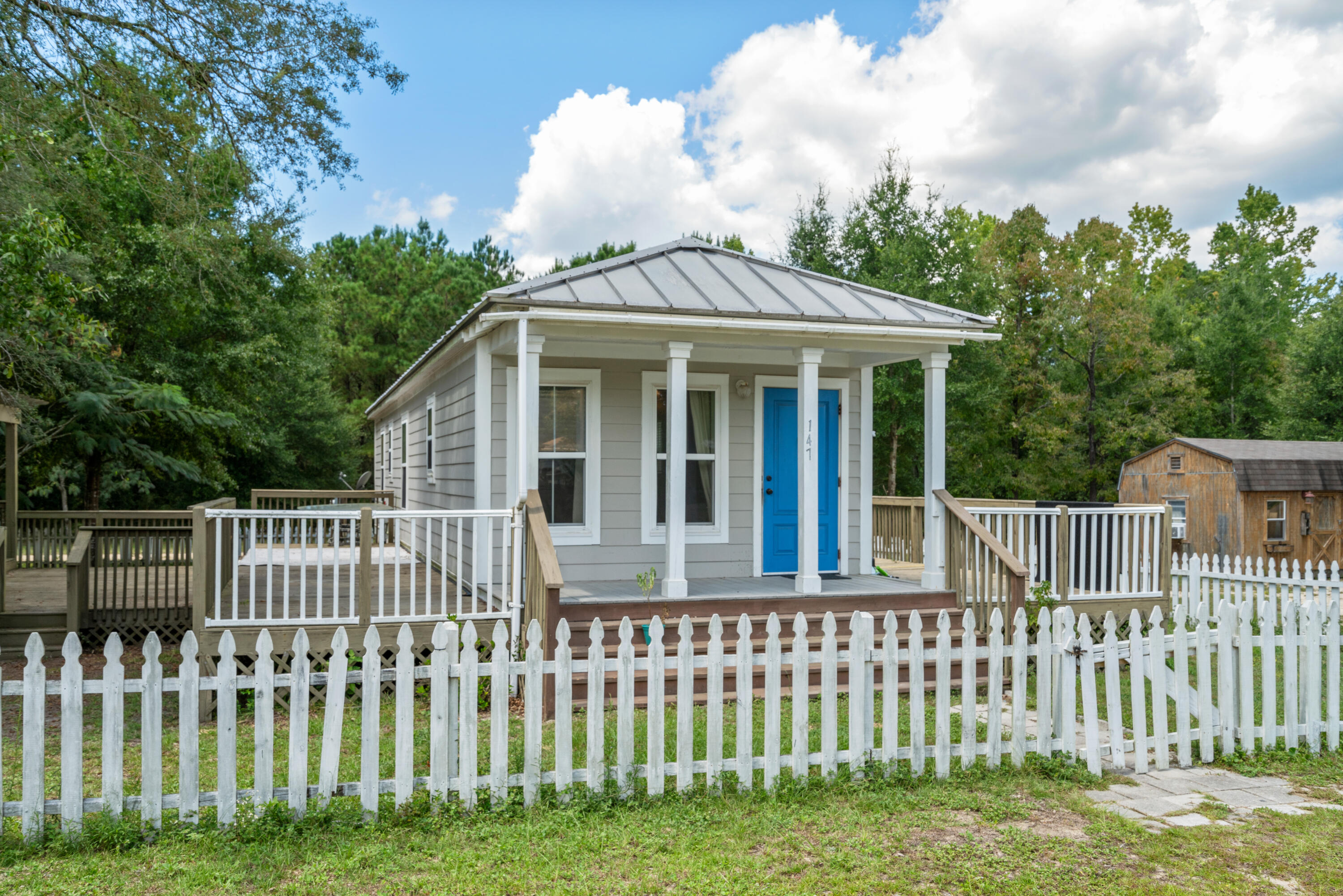 Income-producing Freeport cottages on four oak-shaded lots, just 15 minutes from the Emerald Coast's white sandy beaches! Built to withstand 165 mph winds, these charming homes feature metal roofs, Hardie board siding, double-pane windows, and energy-efficient insulation for low bills. Relax on multiple decks or porches, cook in kitchens with granite countertops and crown molding, and enjoy tile or laminate floors throughout. All tap fees are paid, and the lots allow room for two more additional homes. With established rental income and a prime location between Destin, Panama City Beach, and Fort Walton Beach, this property combines durability, charm, and endless income potential--perfect for investors or those dreaming of a coastal getaway lifestyle! This listing is for 147 & 153 ONLY. This listing consists of a single parcel with four lots and two homes, with the total room count reflecting both properties. The seller is willing to consider selling each home individually: 147 Caswell Branch Road is listed at $221,000, and 153 Caswell Branch Road is listed at $224,000. Showings require a minimum of 24 hours' advanced notice due to tenant occupancy.