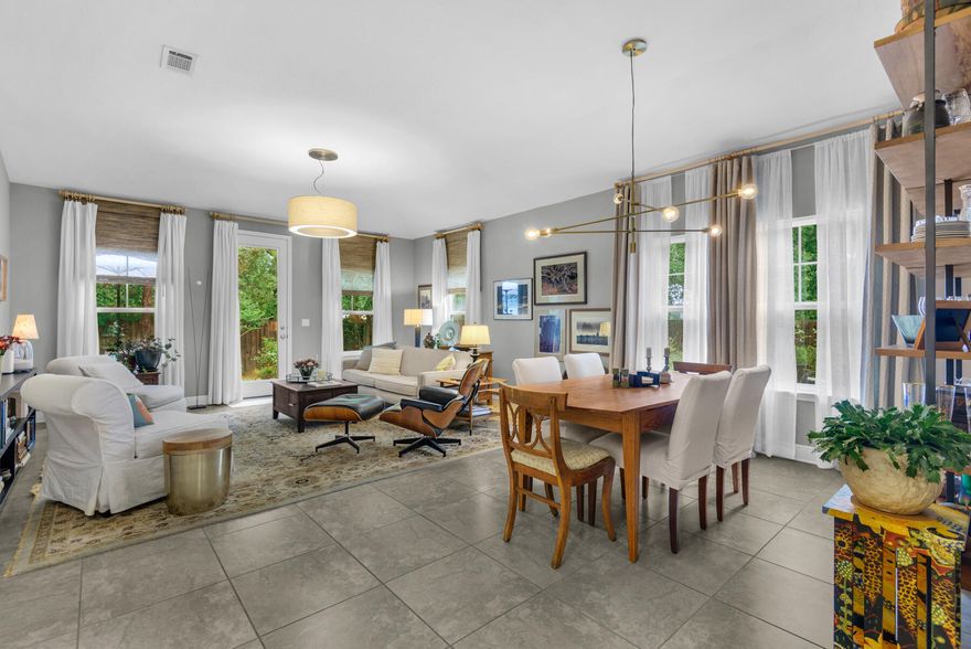 Charming Craftsman-style cottage in a quaint wooded neighborhood with low HOA fees. Located on a quiet cul-de-sac next to the community pool and mailboxes. Features an open, light-filled floor plan, split bedrooms for added privacy, and porcelain tile throughout.The backyard is a delight with azaleas, live oaks, maples, blueberry bushes, and small citrus trees. A pizza oven, fire pit, and partially fenced yard are included.Additional highlights: 10' ceilings in the living room, 9' ceilings in the bedrooms, wood wainscoting in the bathroom, and removable wallpaper in the hallway. Close to grocery stores, parks, the library, and restaurants.