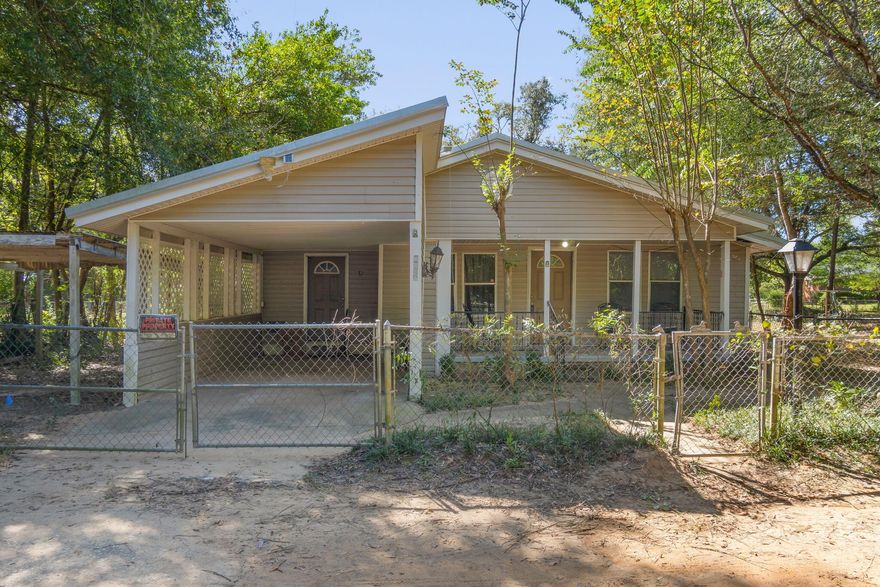 Major price adjustment! Home qualifies for conventional financing!! Located near Highway 90, this home is full of charm including built-in bookcases, solid wood kitchen cabinets, and a quaint built in hutch in the dining room. There's a large laundry room with built in shelving for convenience. The approximate half-acre yard is a blank slate for your ideas, whether it's for gardening or outdoor fun. The property has a a 2019 metal roof! Picture yourself relaxing on the front porch with some rocking chairs, and you'll see the potential for this house as an inviting and cozy home. Moreover, this property is zoned for commercial use, opening up exciting possibilities for a business venture.