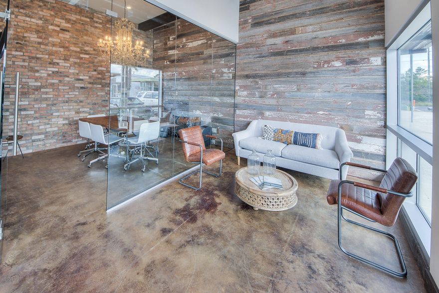 This unique commercial space in The Hub boasts some incredible finishes and a look and feel that any business along 30A would be proud to show off to clients. Some features include brick and barnwood walls throughout, wooden beams across the ceiling, exposed ductwork, pecky cypress doors and cabinetry, concrete countertops, chandelier, and a large glass wall separating the main space and a conference room. The detail and design is apparent as soon as you walk through the door of this exceptional space! The office is made up of a reception area with electrical for a large tv to be hung, a waiting area, a large conference room with television, a kitchenette with sink, small fridge, and microwave, and a bathroom. The space is very open, and could easily be reconfigured to accommodate...