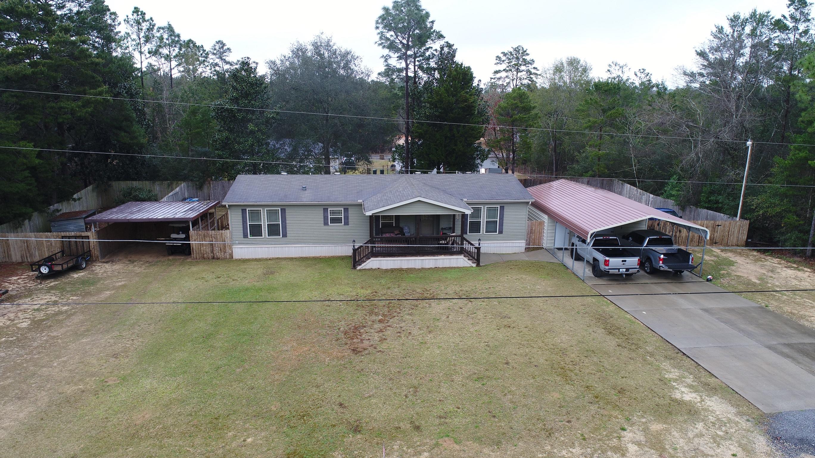 Great opportunity to own a well kept and newer manufactured home on nearly half an acre. Spacious 3 bedroom and 2 bath home with a spacious master bedroom and bath. Home has been meticulously kept and is as clean as a whistle. Large open kitchen and dining room, overlooking the roomy living room. Split bedroom design. Home also features privacy fenced back yard with dedicated dog pen and extra carport. Concrete driveway with metal carport and great workshop/garage with bay door. Make your appointment today to see this great home at a great price!