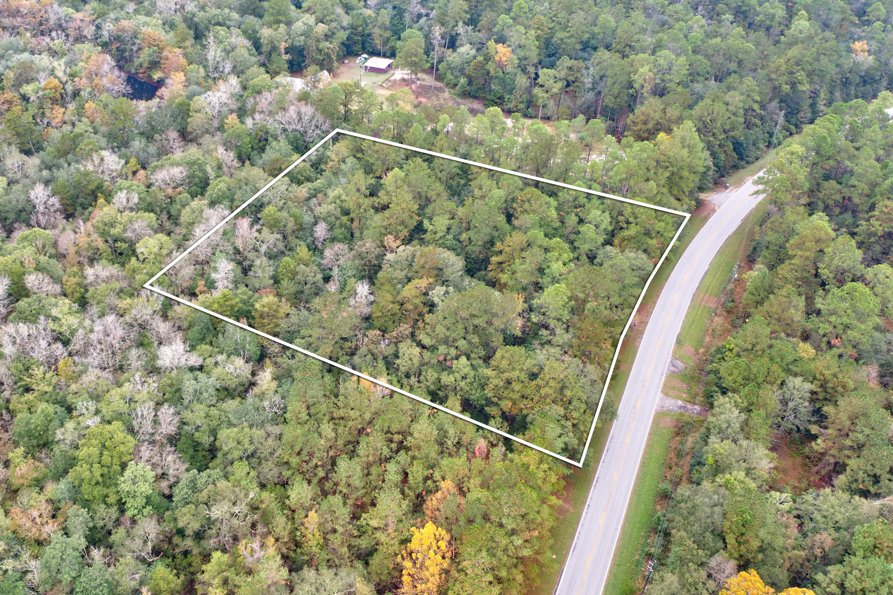 A serene 2.43 - acre property tucked away in nature yet close to conveniences, complete with essential utilities (power, water, and septic) and a small existing structure. This setup could serve as an immediate base for outdoor activities and offers the enticing possibility of developing a cozy ''cabin in the woods''The structure provides a foundation, while the land invites creativity - imagine a warm, rustic cabin surrounded by trees, a garden and space for trails. A tranquil retreat and/or great space for a vacation investment property!! Want to get away amongst the trees, this your place!