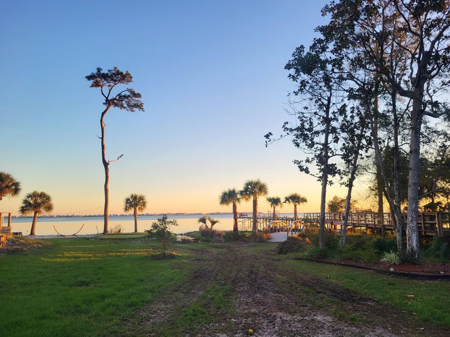 One-of-a-Kind Lot in Magnolia Harbor - Ready to Build! Prepare to be amazed! Nestled in the highly sought-after deeded waterfront community of Magnolia Harbor in Navarre, this incredible lot is anything but ordinary. Fully cleared, beautifully landscaped, and ready for you to bring your dream home to life, it's the perfect canvas for your vision. Unique features include a 5-hole golf putting green, a cozy fire pit, and a charming creek walk-over bridge, making this property truly stand out. You will enjoy breathtaking sunsets, cool Gulf breezes, and the serene lifestyle this property offers every single day. Located just minutes from A+ schools, neighborhood Walmart, shopping, dining, Hurlburt Field Air Base, and the iconic sugary white sands of Navarre Beach, this lot combines convenience with tranquility. This is more than a lotit's the foundation for your future. Don't miss this opportunity to own something truly special.