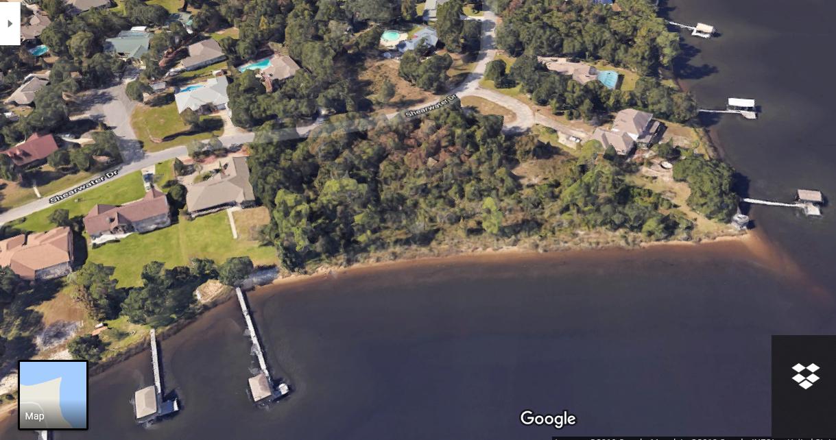 Waterfront lot, approximately 100 feet, on East Bay to build your dream home in a quiet well maintained neighborhood with covenants and no HOA. Per Wetland Sciences, Inc., approximately 4/10 of an acre of buildable uplands. Simply permitted piers/elevated dock over wetlands can be built to waterfront. Wetland determination available. Gas company is conducting feasibility study to add gas lines to the area. Close to Hidden Creek Golf Course, the white sand and emerald water of Navarre Beach and a short drive to shopping. Neighboring vacant lots also shown in photos. Lot 5 sold for $120,000 in 12/18. Parcel 4, 02-2S-27-4575-00C00-0040 is available to purchase as well. No current improvements or utilities to property.