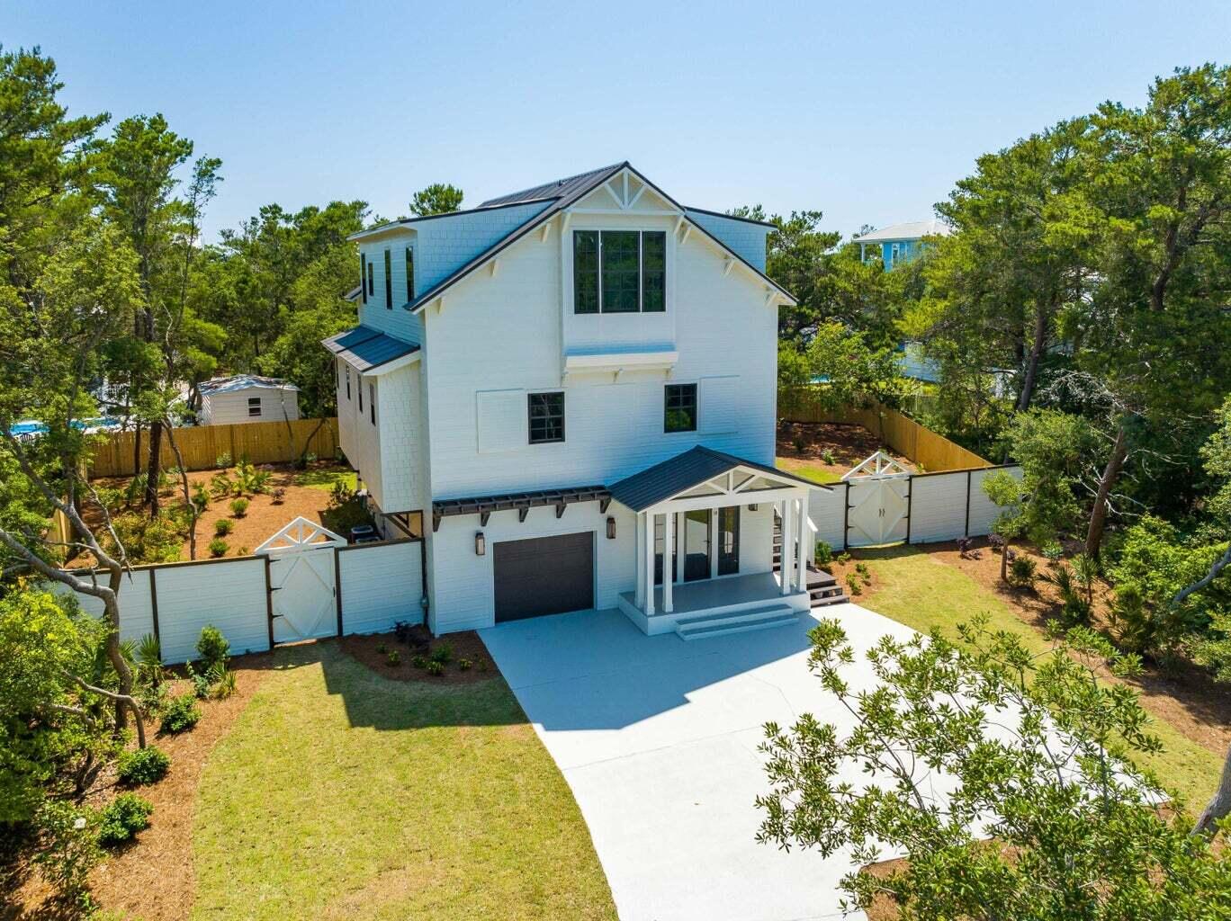 Experience the charm of this fully renovated 4-bedroom home, situated on a peaceful cul-de-sac in a highly sought-after, non-rental neighborhood. Thoughtfully designed with expansive porches along the south side on both the first and second levels, this home is perfect for enjoying indoor-outdoor living.

Inside, the home offers exceptional versatility, including a custom-built bunk room, a spacious one-car garage, and additional parking for 3+ cars in the driveway. The first floor features a guest suite with a bedroom, full bath, living area, and kitchenette, ideal for extended family or visitors.

On the second floor, you'll find an inviting open-concept living, dining, and kitchen area complete with a wet bar and cozy fireplace perfect for entertaining. The master suite includes a luxurious bath with double vanities and a generous walk-in closet. A screened-in porch stretches across the back of the house, inviting cool breezes for a serene retreat.

The third floor includes two additional bedrooms with a shared bath, as well as a second bunk room with its own bathroom. A large fenced backyard provides ample space for outdoor activities.

This stunning home blends modern amenities with classic Southern charm don't miss this unique opportunity!