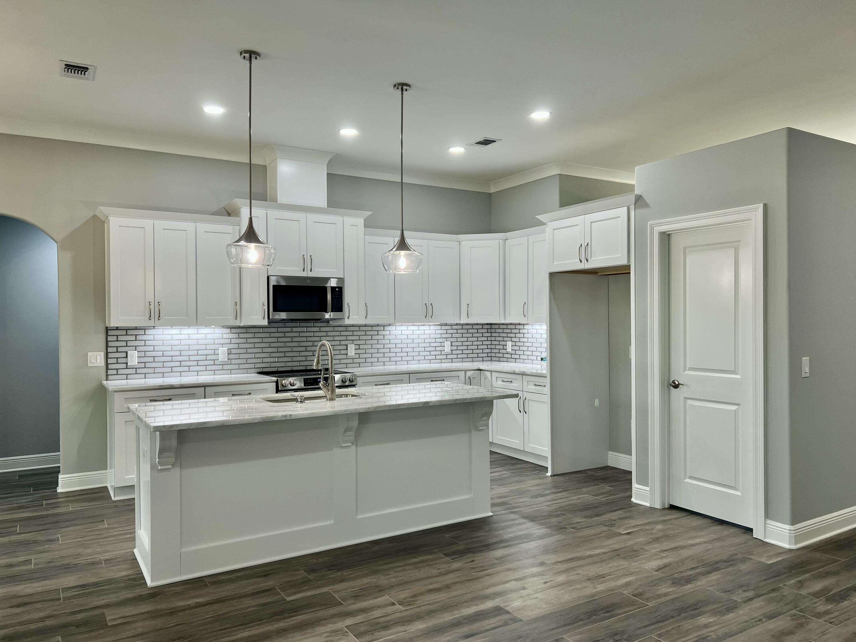 NEW Custom Built Home in Holley By The Sea,Enjoying all the Club House amenities including :Pools,Fully Equipped Gym,Tennis Courts,Waterfront Park & Deeded Access to Santa Rosa Sound This luxurious 4 bed/3 bath Tri split floor plan is under construction...and will be ready late Sept 25 ~Great Location within HBTS..with easy access to Navarre Beach, shopping and Hwy 98 to Hurlburt Field AFB.This Stunning Robbins Builders Custom Home offers trend setting design & features~Greeted by the entrance foyer open to the Formal Dining and Office through to your open floor plan ~Large Gourmet kitchen enjoying shaker cabinets with crown molding ~ beautiful quartz counter tops~tiled back splash~under mount sink~S/S Appliances~Large wrap around deep pantry ~Center Island with open flow to the breakfast nook and family room, Wood Plank staggered tile through the foyer,dining room, main living area, laundry and bathrooms. Large Master with trey ceiling & ceiling fan. Master bath offers a large tiled shower /separate soaking tub~Quartz double vanity with picture frame mirrors & deep closet.Two additional bedrooms are a great size with double closets~ ceiling fans and share a bathroom with a tub/shower combo ,linen closet and WC.Third additional bedroom is separate from the other rooms and would make a perfect guest/teen suite with its own bathroom and access out to the large covered porch.Laundry room & over sized 3 car garage ...ideal for the larger trucks and still plenty of room for all the outdoor toys. Home is situated on a 10 x 200 lot with grassed yard ~sprinkler system~ lawn pump and well with digital programmable timer for easy care. TAEXX in wall pest control system~ Fabric Shield Hurricane protection and dimensional shingle roof for lower insurance premium. Upgrades include crown molding, recessed lighting ,framed mirrors, deluxe lighting package,50 Gallon water heater, garage door remotes, attic drop down stairs~ to name a few......Call today for further information ,colors and construction status.** pictures are of previously closed homes so colors ,fixtures and finishes may vary .