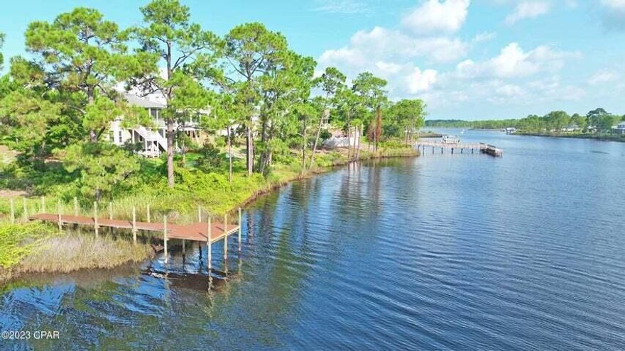 Introducing 314 Turtle Cove, Panama City Beach, FL Nestled in the serene beauty of Turtle Cove, this cleared, waterfront property is a true gem. Situated on a generous 0.23-acre lot, it presents a unique opportunity that sets it apart from the rest. This is the only waterfront lot currently with it's own private dock! Located on the picturesque shores of Lake Powell, this property offers not only a tranquil waterfront setting but also access to the largest coastal dune lake in Florida and North America, offering a truly unique experience. Lake Powell offers activities like kayaking, paddle boarding, bird-watching, nature study, hiking, and both fresh water and saltwater fishing. Motor boats and jet skis are permitted on Lake Powell as well. Such unparalleled access to this unique body of water is a rare privilege, as very few waterfront lots are available at all on Lake Powell. Immerse yourself in the exclusive amenities of Turtle Cove, where a beautiful waterfront clubhouse awaits. With its state-of-the-art exercise room, inviting pool, and welcoming community room, every day feels like a vacation. Engage in leisurely fishing, enjoy picnics in the delightful picnic area equipped with a BBQ Pit/Grill, and bask in the breathtaking views from the dock. For those seeking an active lifestyle, the tennis courts provide the perfect space to indulge in friendly competition. 314 Turtle Cove presents an exceptional opportunity to build your dream home in a highly desirable location, where tranquility, natural beauty, and an array of recreational options await. Don't miss your chance to claim this waterfront paradise as your own. Act swiftly and make this extraordinary property yours today!