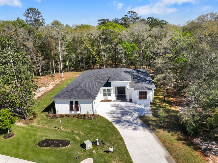 Construction is now complete on this new, custom home. The craftsmanship throughout the home is evident. Custom features in this single level beauty include: a light interior w/character and luxurious details.  A large, covered porch steps down to a 480sf paver patio overlooking the wooded area of one of the largest lots in Hammock Bay (.92 acre).  Plank flooring, granite and quartz countertops, crown molding, recessed and custom lighting, 10 foot ceilings throughout, tankless water heater, tile showers, garden tub, his/her custom closets, gas cooktop, dbl ovens, 6X11 oversized island w/shiplap detail.  Exterior features include: brick/hardiplank, gutters, professional landscaping w/irrigation system and well, tongue and groove porch ceilings 11X32 rear porch, Heavily wooded for privacy.