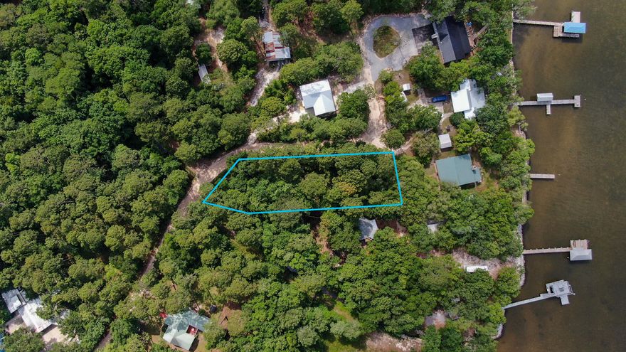 Large lot 0.64-acre one tier off the bay to build up and should capture views of the bay. No HOA or build out time frame. Upgraded county park located under the Hwy 331 bridge which offers boat launch, restrooms, and fishing is within a mile from this lot. There are several restaurants close by or you can travel south a short distance to the beach, shopping and several more restaurants.