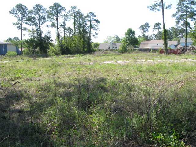 BANK OWNED. REDUCED. Nice level 3 acres on Greenacres Rd. 1 block off Beal Pkwy. Owner consider dividing into 1 or 2 acres. Mostly cleared with several very large pine trees. Existing paved median for easy access for traffic going west. Posted speed limit is 35mph. Existing water and sewer taps. We have a survey. The property has 4 different tax Id numbers. BANK OWNED.