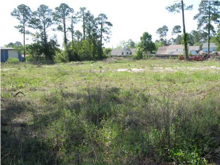 BANK OWNED. REDUCED. Nice level 3 acres on Greenacres Rd. 1 block off Beal Pkwy. Owner consider dividing into 1 or 2 acres. Mostly cleared with several very large pine trees. Existing paved median for easy access for traffic going west. Posted speed limit is 35mph. Existing water and sewer taps. We have a survey. The property has 4 different tax Id numbers. BANK OWNED.
