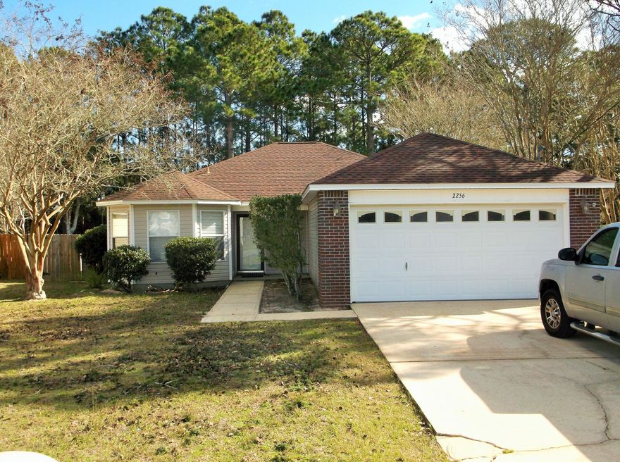Interior just got a fresh coat of paint, new carpeting in Bedrooms, new LVP flooring in Living Rm, kitchen, breakfast nook and laundry Rm.  New Built in Microwave.  Dimensional Shingle Roof replaced in 2019. HWH new 2025. Large sized backyard for whatever you would like, i.e...pool, pets, garden... Nice, covered patio in backyard.  Close to shopping and also the Okaloosa county line.  Close to Navarre Beach.