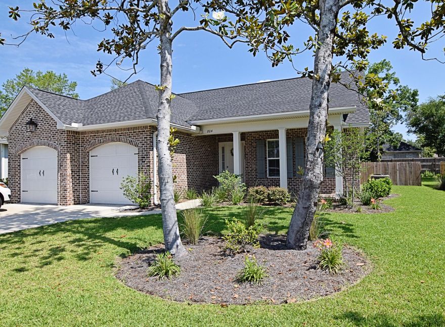 Are you looking to move into Magnolia Woods now?? Why wait to build. This barely lived in, 4 bedroom, 3 full-bath home has all the kinks worked out and many upgrades including hardwood flooring throughout, no carpet in the bedrooms, fully vented range hood/gas cooktop and charming chandeliers! Approaching your home you will find a beautifully landscaped lawn and open, brick front porch, perfect for a rocking chair or two. The two front bedrooms are large and accommodating and outfitted with Jack and Jill spacious bathroom. Gorgeous living room, kitchen and dining area share one large open space, adorned with crown moulding. Breathtaking 8 ft. doorways, over-sized windows, upgraded fixtures, and ceiling fans.Kitchen island provides extra space for casual dining.