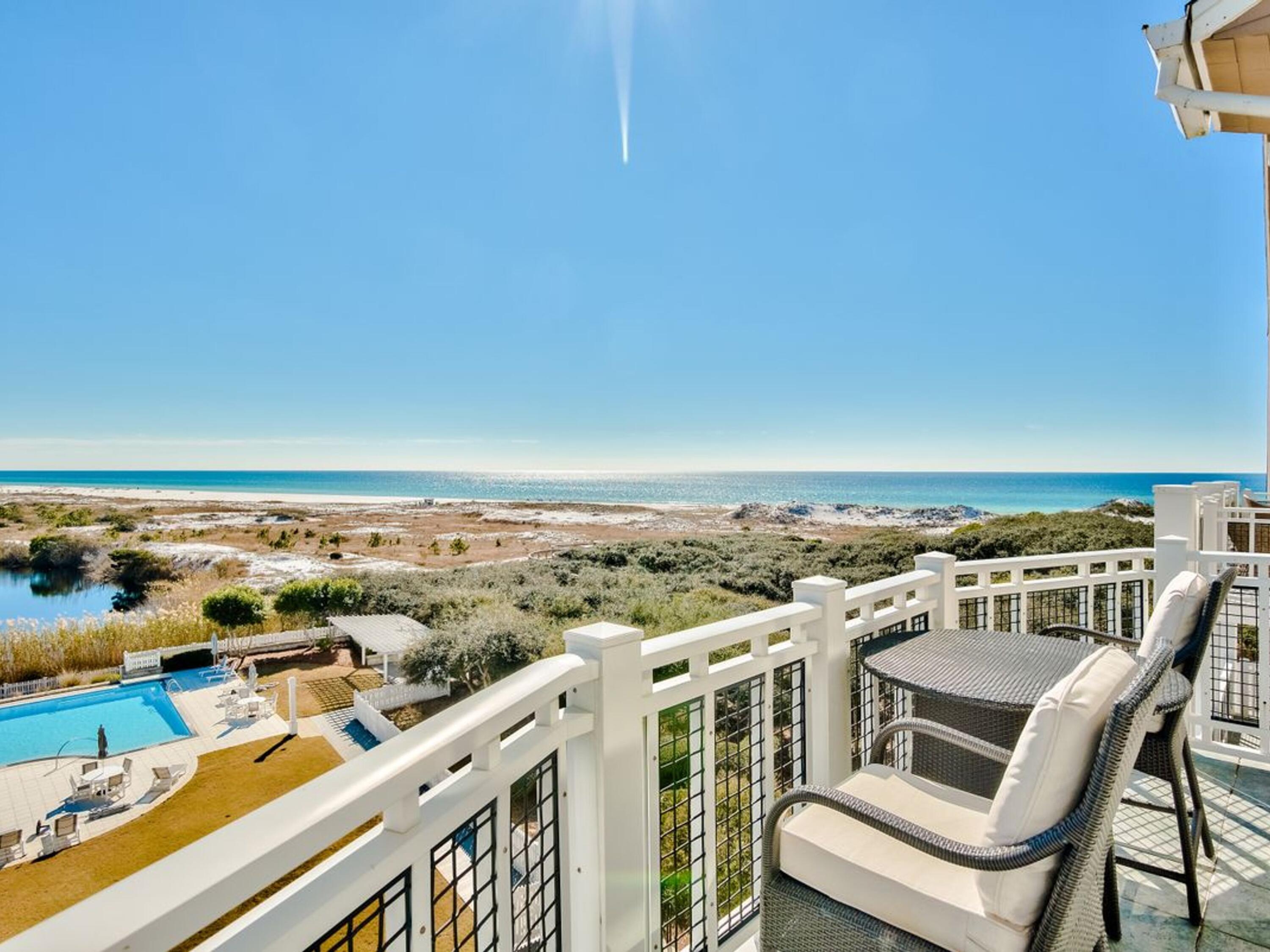 The soaring two story living room captures panoramic vistas of the Gulf and Dune Lake in the highly sought after building of Compass Point II in Watersound Beach.  The open kitchen is accented with custom cabinetry and luxury Viking appliances. The living area features 20' ceilings, highlighted by oversized windows. The third floor loft could be utilized for additional sleeping or as a secondary entertaining space to enjoy the exquisite views from sunrise to sunset.  The oversized gulf front master suite is accented with a private balcony and a large master bath featuring separate shower and soaking tub. Two additional guest suites offer designer furnishings and private ensuite baths.  A  detached garage is included to provides optimal storage for your golf cart, bicycles and beach toys.