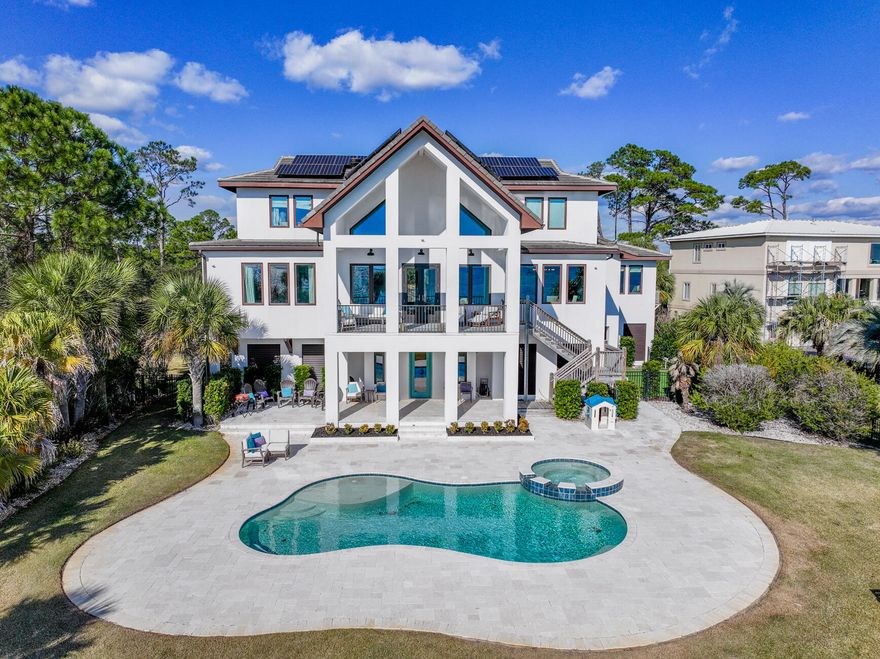 Welcome to your stunning waterfront home and private gated community! You will be amazed at the views and privacy as you drive over the wooden bridge that leads directly to this luxurious 5 bedroom home.  Walking into the home, you will be greeted with your private office with waterfront views, along with a newly added theatre room. There is a half bath and access to the covered patio and heated saltwater in-ground pool and spa. On the main level, there is an open concept kitchen; equipped with custom cabinetry, new tile backsplash, quartz counter tops, gas stove, and stainless steel appliances. The living room, with vaulted ceilings and incredible waterfront views, boats a gorgeous wood fireplace with new tile. The pantry off the kitchen has beautiful custom sliding barn doors, and leads