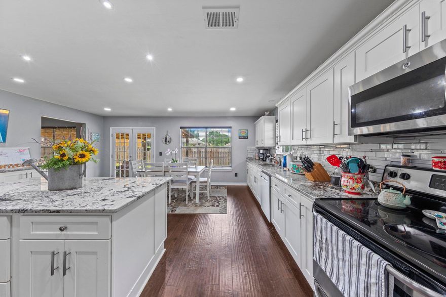 Price Improvement. AND seller is offering $5,000 towards rate buy down or closing costs!!! Just move in! Wonderfully updated 4/2 with 2698 sq. ft. all brick home and south of I10! No worries if this kitchen is the gathering spot for get togethers. It measures 19x19 with a large granite topped island, all stainless appliances and soft close drawers. There is a spacious sized laundry room/pantry off the kitchen and on the other side of the room you have French doors that lead out to your covered patio for your morning coffee. Entering the home you will first notice it is an open floor plan. There is an office to the left that is currently being used as a workout room and to the right is a great sized dining room. Straight ahead is the big living room with fireplace for those chilly nights