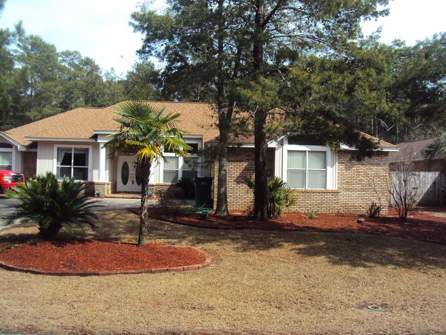 Lower electric bills with solar powered, single story home in desirable gated community of Parkwood Estates. Power company pays you for any excess power produced, significantly reducing your power bill. Open floor plan, split bedroom home has 11' ceilings with lots of light. Walk in and you see the view. Covered porcelain tile patio, crystal clear pool and backyard bordering wooded Eglin range. The screen enclosed, solar-heated 20'x45' pool has a huge deck area for entertaining. Large kitchen has granite countertops, lots of cabinets and view to pool and woods. Breakfast room has bay windows overlooking the pool. Separate master area with double door entry and access to patio and pool. Large walk-in closet and bathroom with his/hers cultured marble vanities, jetted tub & separate