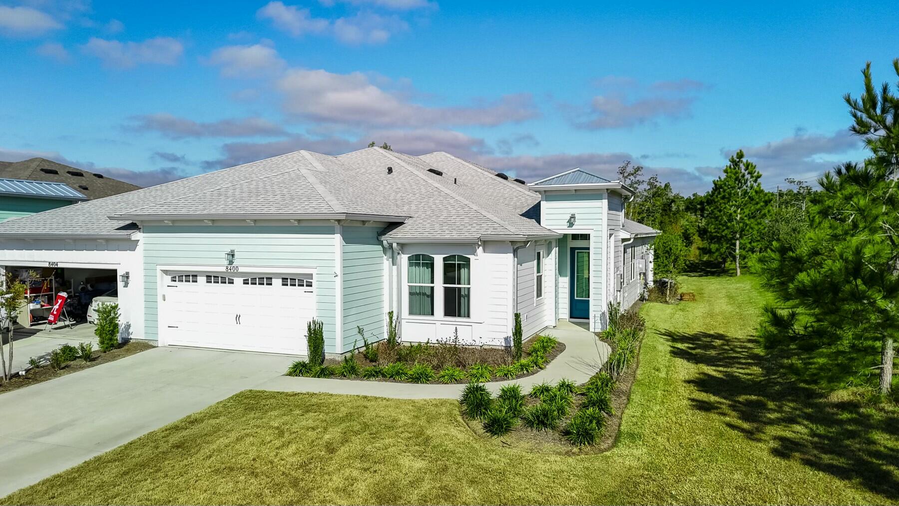 Welcome to Latitude Margaritaville Watersound, a luxurious 55+ gated community on Panama City Beach! This beautifully-designed, single-level, Barbuda Bay Villa offers 2 bedrooms, 2 baths, a den, covered lanai, 2 car garage and 1,787 square feet of living space. This 2023-built, highly-upgraded Villa is so welcoming and you'll love enjoying the indoor-outdoor living we love in Florida for all months of the year. As you step into this Villa, you'll find 9' ceilings, luxury LVP flooring throughout, and an open concept kitchen, living and dining area. An extended oversized kitchen island with beautiful Quartz countertops and upgraded Kitchen Aid suite stainless appliances is perfect for entertaining guests and sipping on margaritas...because it's always 5 o'clock somewhere! The living room features a tray ceiling to 10' and a large sliding glass door to the covered lanai. Just off the living room you'll find a true retreat. This primary suite offers views of your beautiful back yard, tray ceilings to 10' and a spacious primary suite bath with double vanities, a zero-entry tiled shower and a closet you've always dreamed of! 

This true split floor plan makes it great for guests to come visit and offers a full bedroom and bathroom on the front of the home. An added den is also great for flexibility for those who wish to work at home, have a bonus room for crafts or even additional sleeping space if desired. The laundry room is large and offers upgraded cabinetry and a laundry sink with access to the 2-car garage. 

This home offers the following as upgrades: hurricane rated impact windows, impact hurricane rated garage door, pull down attic stairs, golf cart charing power supply for golf cart, LVP flooring, custom honeycomb window coverings, glass kitchen cabinets, pull out drawers in the kitchen cabinets, Kitchen Aid stainless appliances, natural gas range, Quartz countertops, tile to ceiling in showers, glass shower enclosure in primary suite, makeup vanity area in primary suite, undermount sinks, custom vanity mirrors, 8' doors, recessed lighting throughout, designer lighting, cabinet hardware, white shaker cabinetry and higher electrical outlets for TVs. 

Do not miss this opportunity to live in this gated community and start living your best life in Latitude Margaritaville Watersound! This community offers remarkable amenities where you'll enjoy a fitness center, movie theater, pet spa, business center, workshop, restaurants, resort-style community pool with beach entry and swim-up bar, tennis and pickle ball courts, bocce ball courts, kayak launch & more. 

Ideally located just minutes from the sandy beach, this Jimmy Buffet inspired community is a destination where it's always 5 o'clock somewhere! Inquire today to begin living your best life!