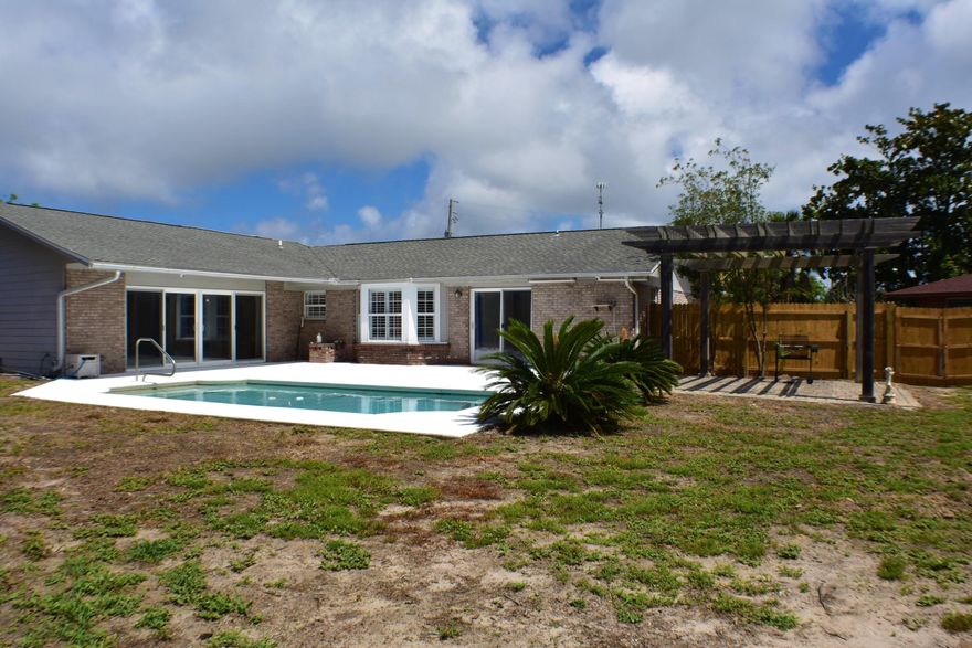 Fantastic family home in the Point Royal Subdivision with lots of upgrades and a pool! This 4BR/2.25BA home includes a living room, a den with built-in bookcases, a huge family room with fireplace (sellers say could be converted back into a garage), an enormous Master Suite, and a bonus/man cave with its own entrance and a brand new AC! The kitchen is practically brand new with stainless steel appliances and granite counters. The master bath includes a jacuzzi tub, a huge separate shower, and a double sink vanity. The backyard is privacy fenced and you'll love the saltwater chlorinated in-ground pool, the new pergola, and there is a workshop in the back corner. This house is ideal for both entertaining and raising a family! You're just around the corner from shopping, the beaches,