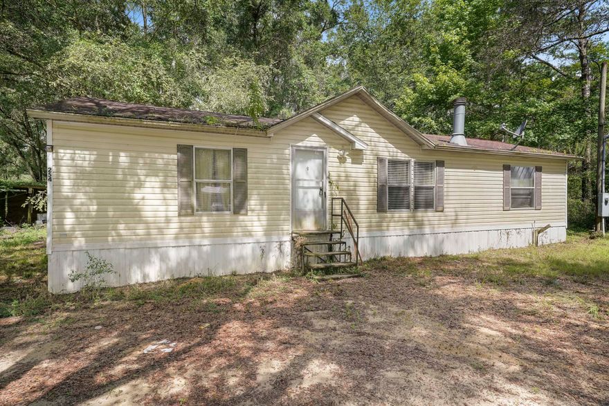 Estate Sale...Permanent Living...Investment Opportunity! Located close to the Choctawhatchee River, Black Creek, and a short drive to area beaches this ''Double Wide'' Manufactured Home built in the year 2000 could use some updating to financially benefit the buyer greatly. The property has been vacant for a short while, and sits on a large lot with over One-Half Acre of land. It has three bedrooms, 2 full baths, and a good size kitchen with an ample living area totaling 1152 Square Feet of heated and cooled space. The most recent sale of an updated Manufactured Home in this general area sold for $167.21 a square foot. Upside potential for sure...come see it today!