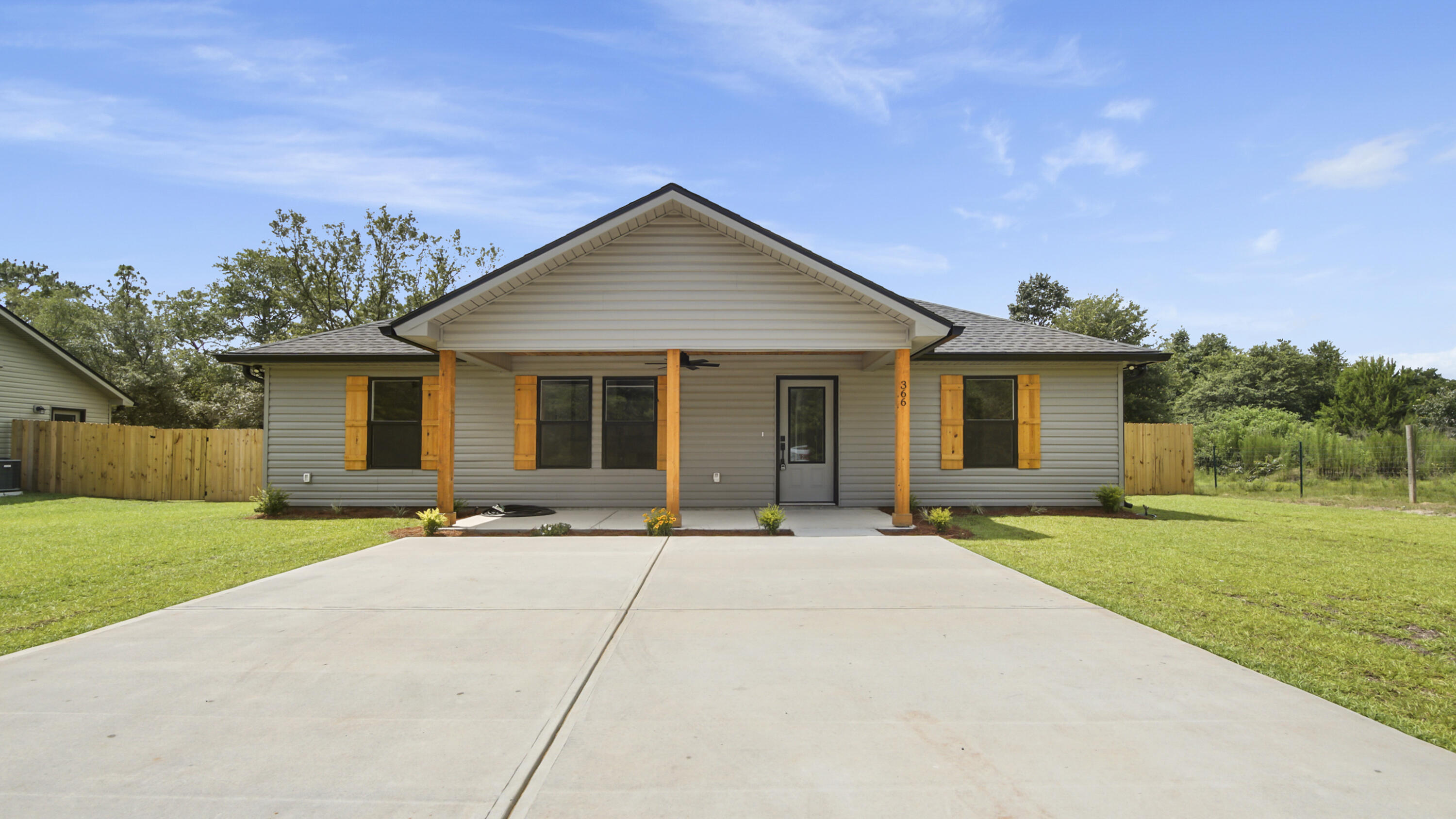 Welcome to this stunning new build where quality meets value. Front porch is inviting with cedar posts, cedar-clad ceiling, and ceiling fan. The open concept with vaulted ceiling and luxury vinyl plank flooring add a bright and durable touch throughout. The kitchen features a large island, quartz countertops, soft-close cabinets, GE stainless steel appliances, and farmhouse sink. The primary bedroom offers comfort and privacy with an en-suite bath that boasts a tiled shower and upscale fixtures that gives a luxury experience. Outdoors, enjoy a fully sodded yard, a 6-foot privacy fence perfect for entertaining and family fun. Let's not forget the expansive laundry room for those families that need extra storage. Seller to contribute $9000 in closing costs with full price offer.